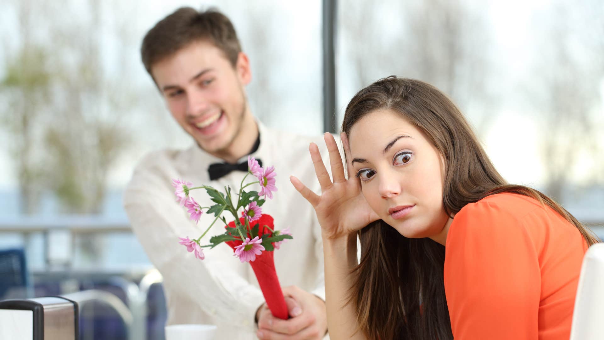 woman chipping away at man's confidence by not appreicating gift