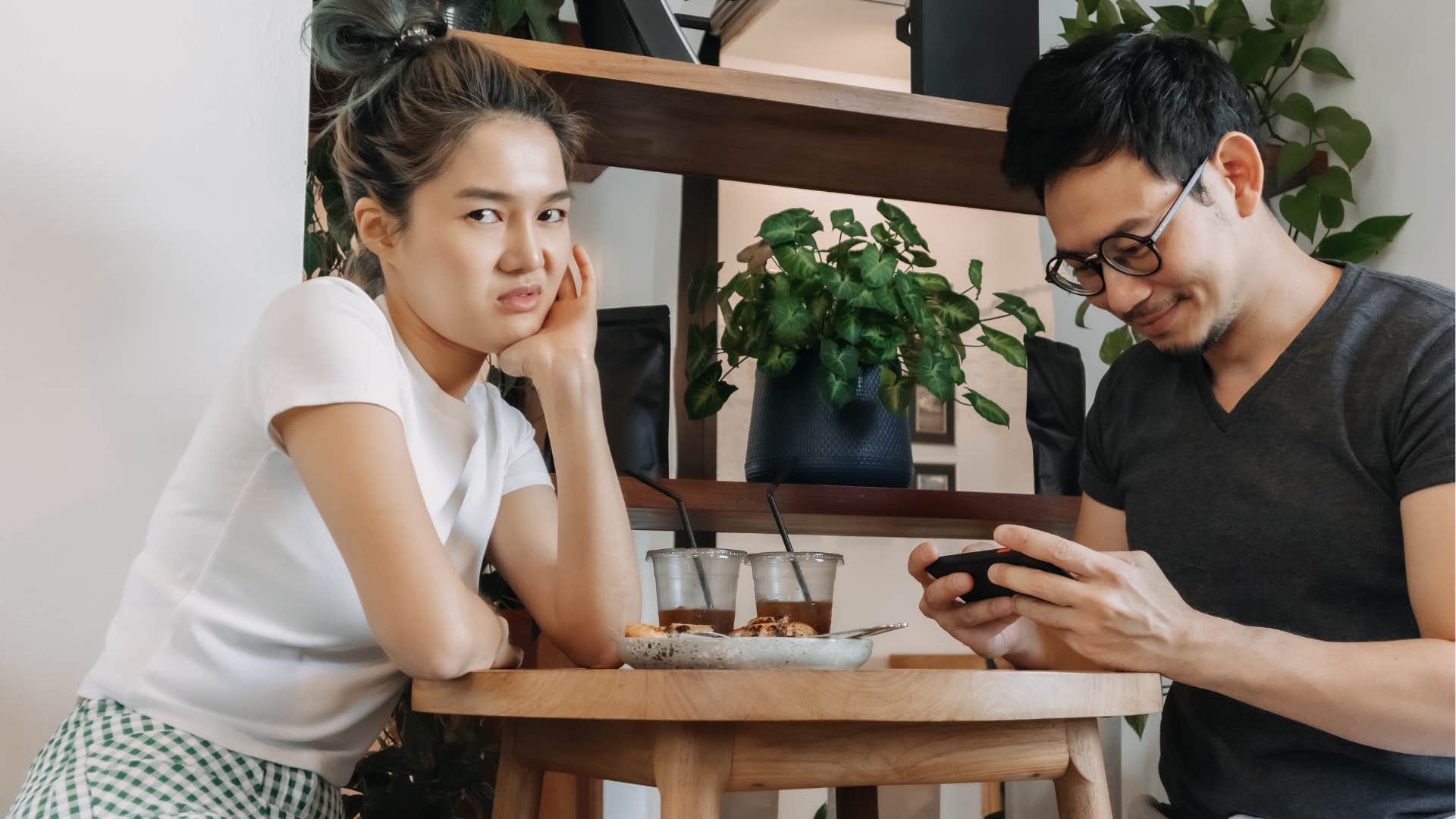 woman chipping away at man's confidence by not taking his work seriously