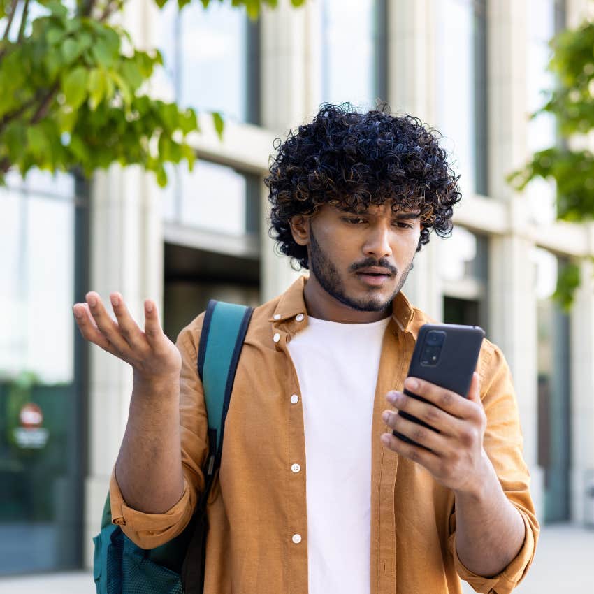 man reading a bland text message from a boring woman