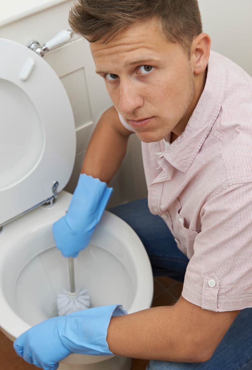 man cleaning the toilet which is the chore Americans dislike most