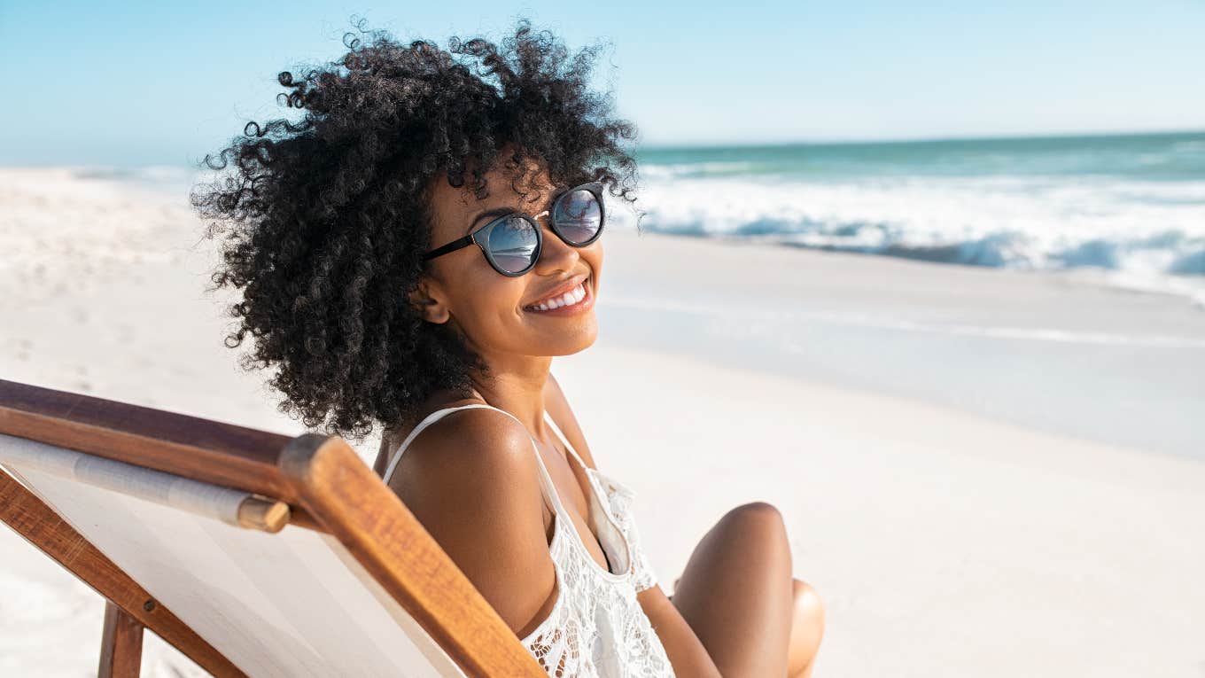 woman sitting on beach enjoying perfect vacation