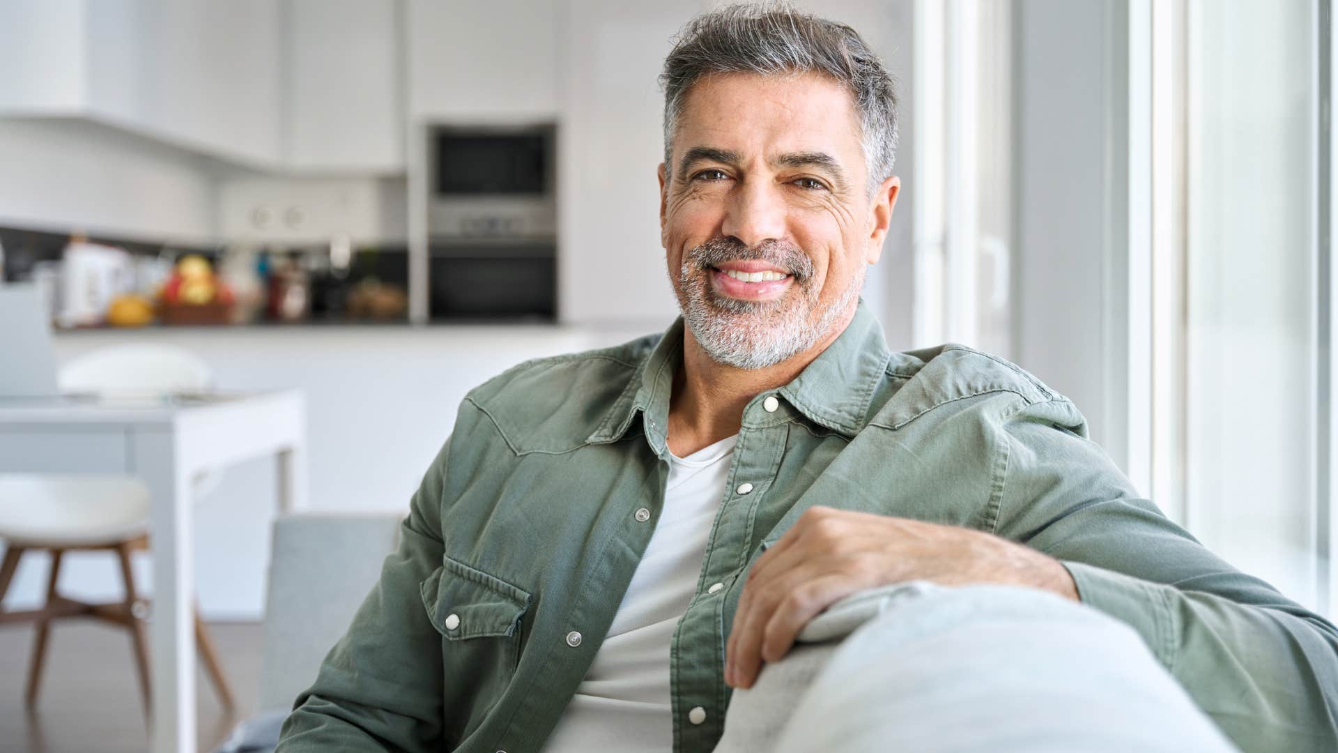 man smiling enjoying alone time at home