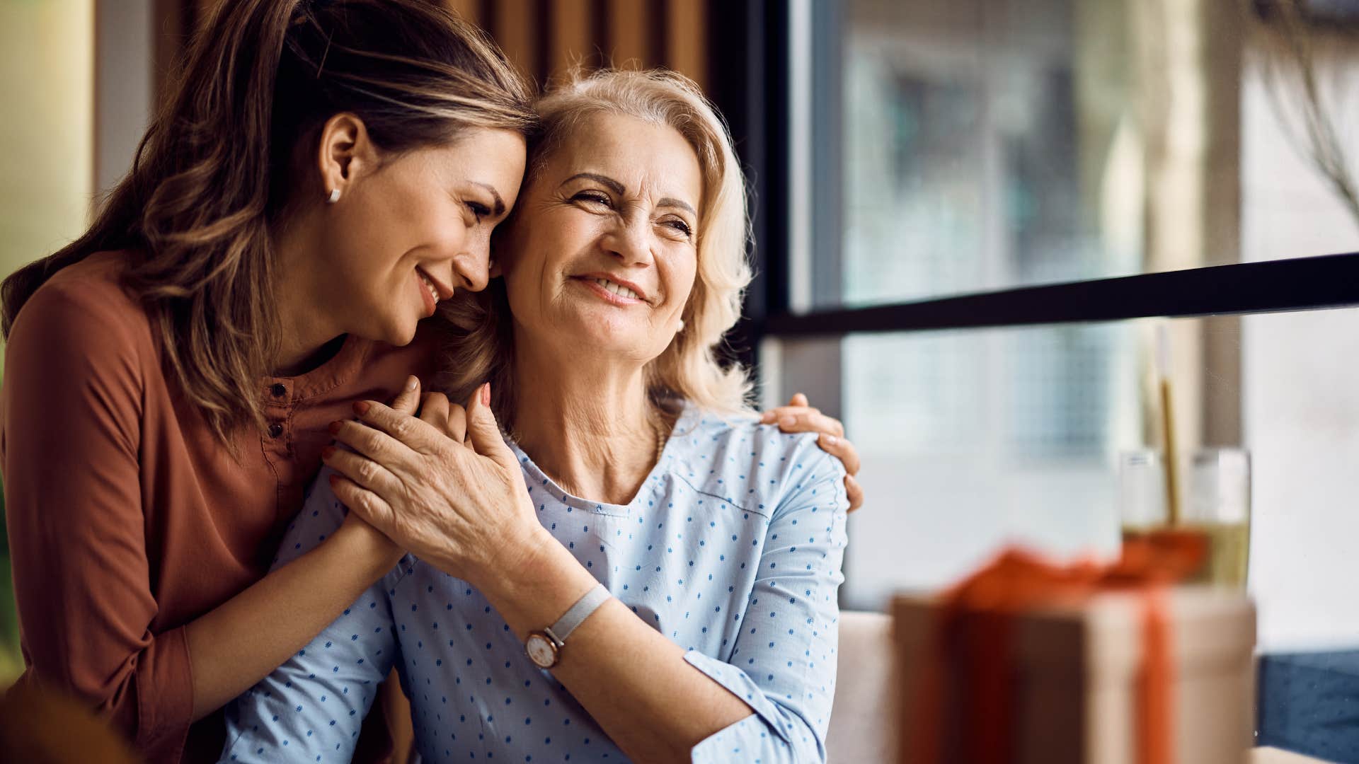 adult daughter hugging mom