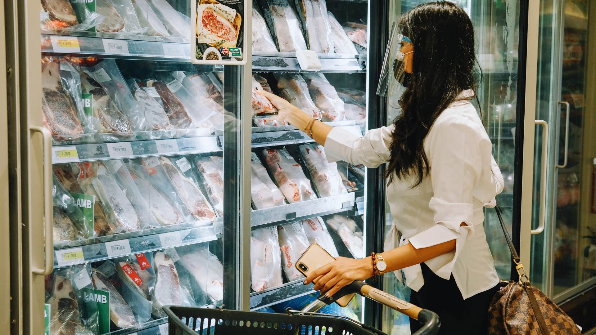 woman stocking up on freezer stable foods before shelves go empty