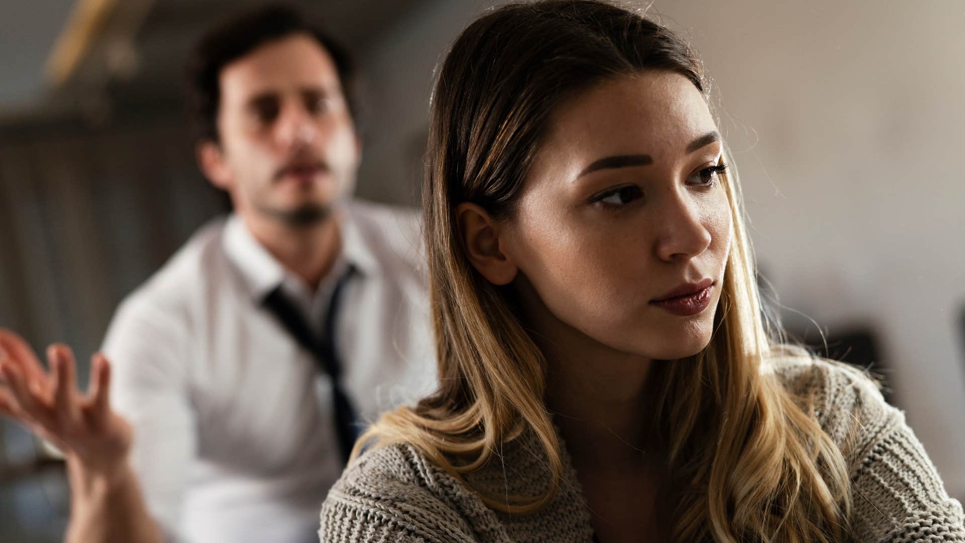 woman turned away from controlling partner