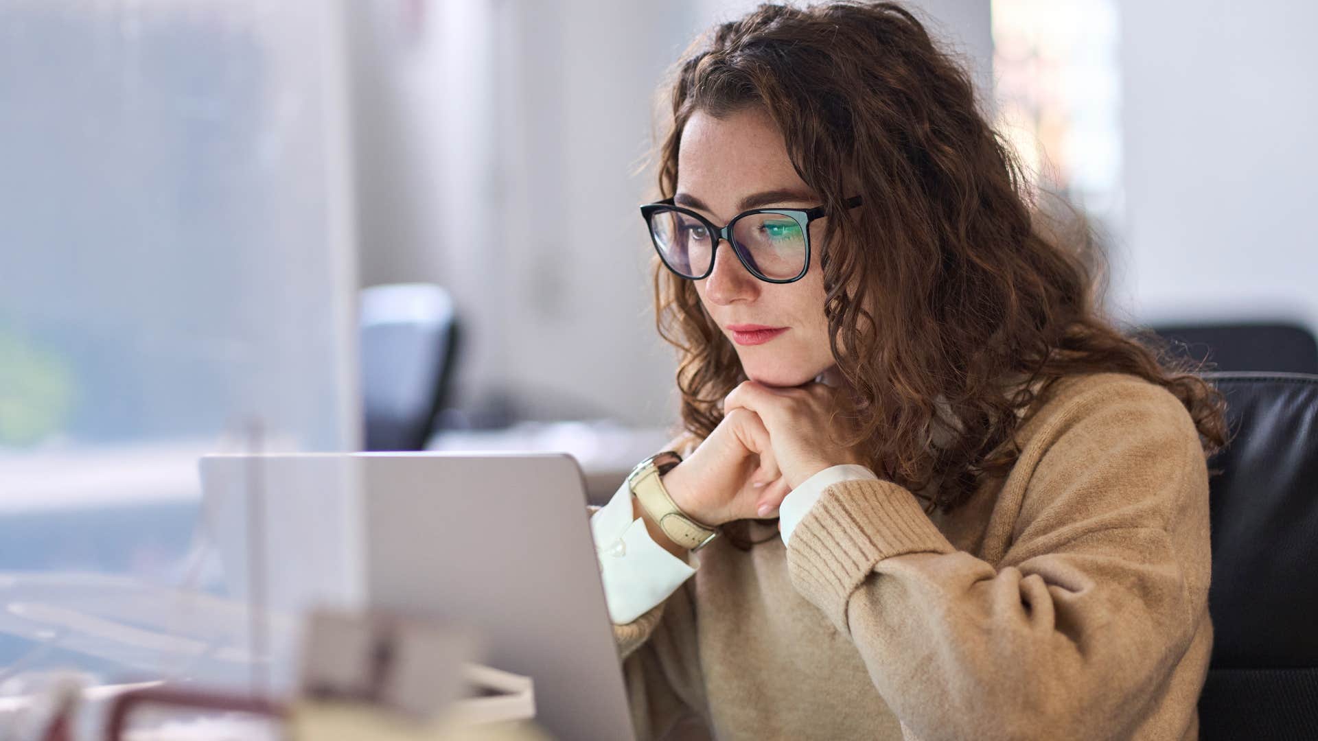 Woman avoiding conflict at her work desk.