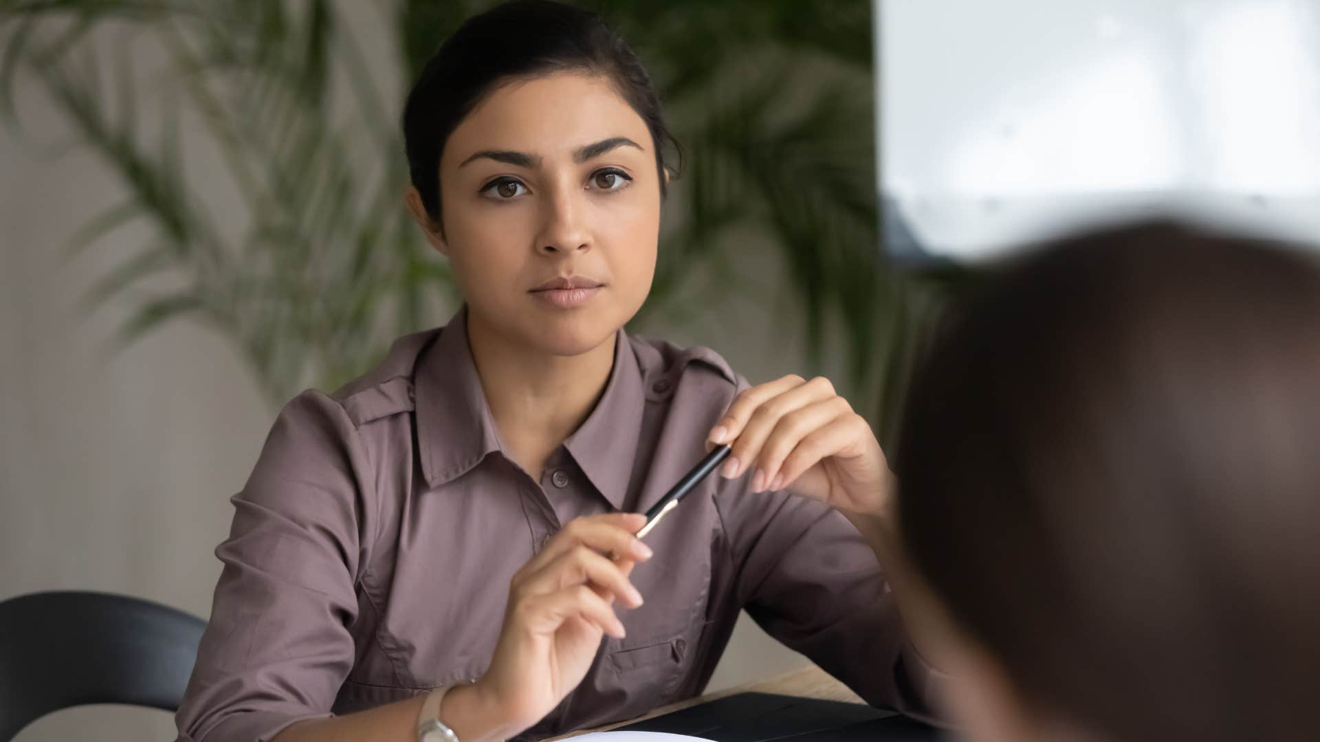 Upset woman interrupting in meetings.