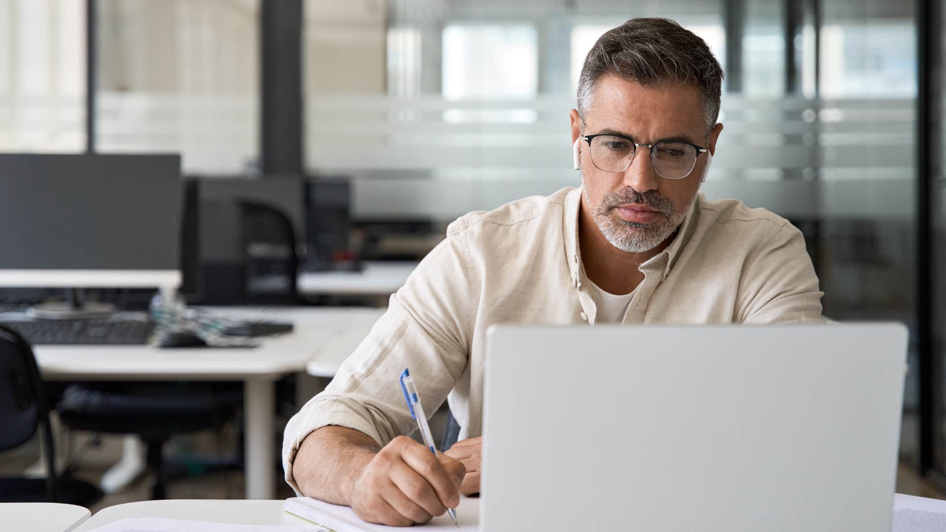 Man being unapproachable with headphones on at work.