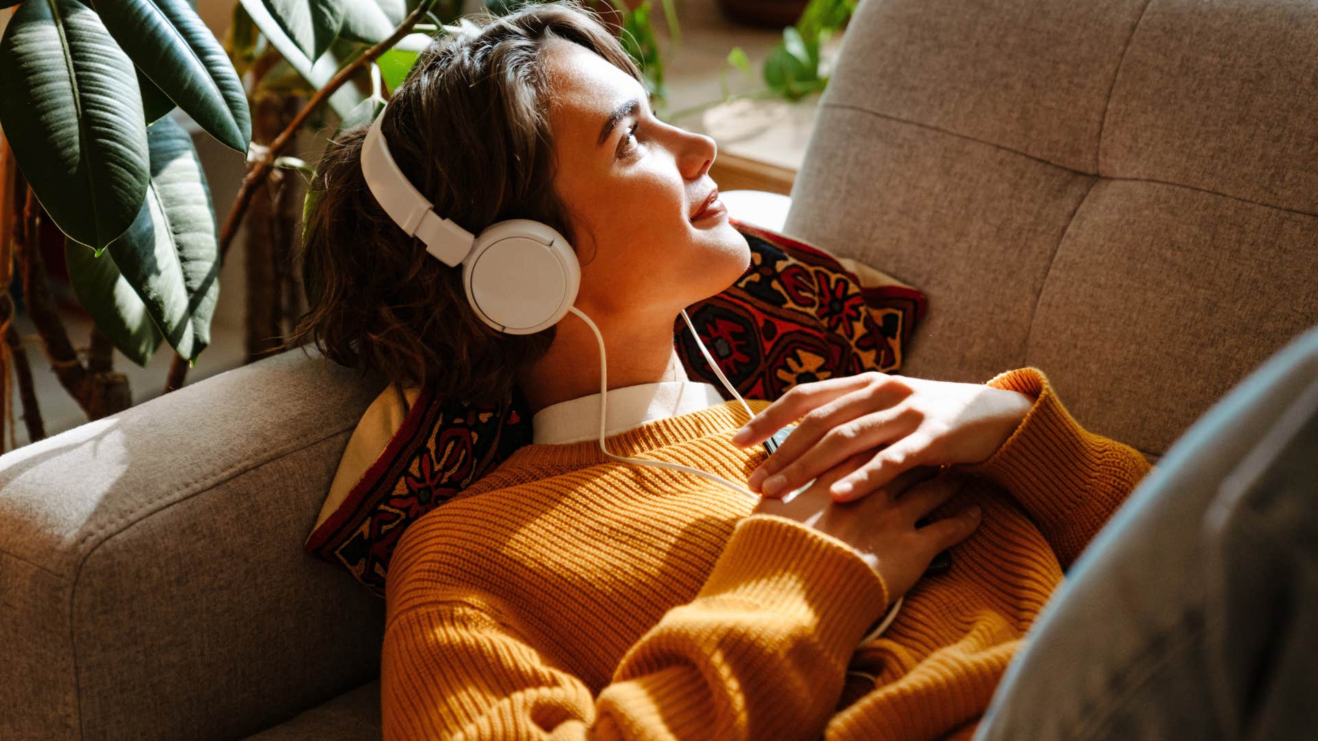 gen z woman who knows that rest is productive laying on couch