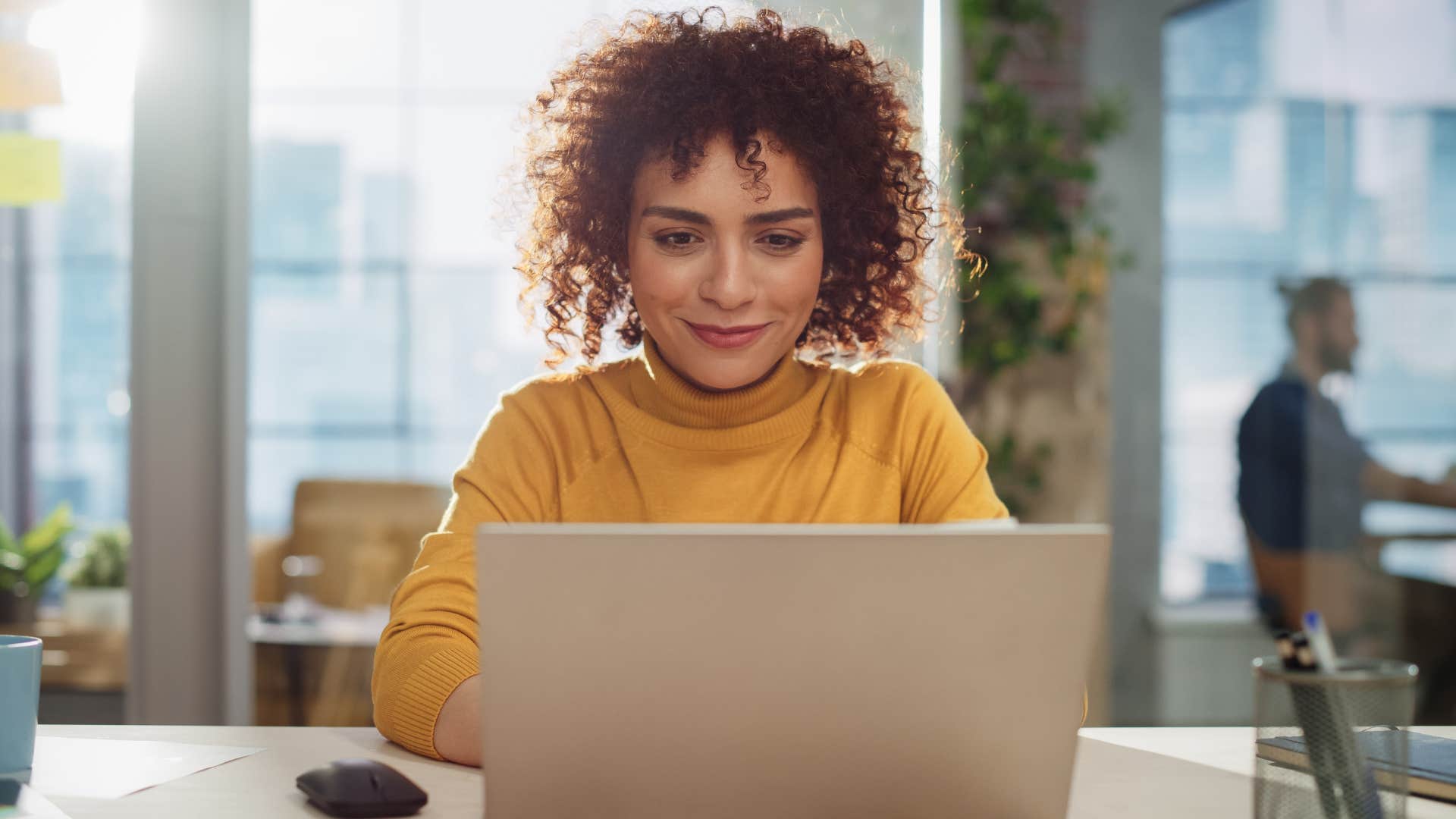smiling woman at work refusing to celebrate workers burning out