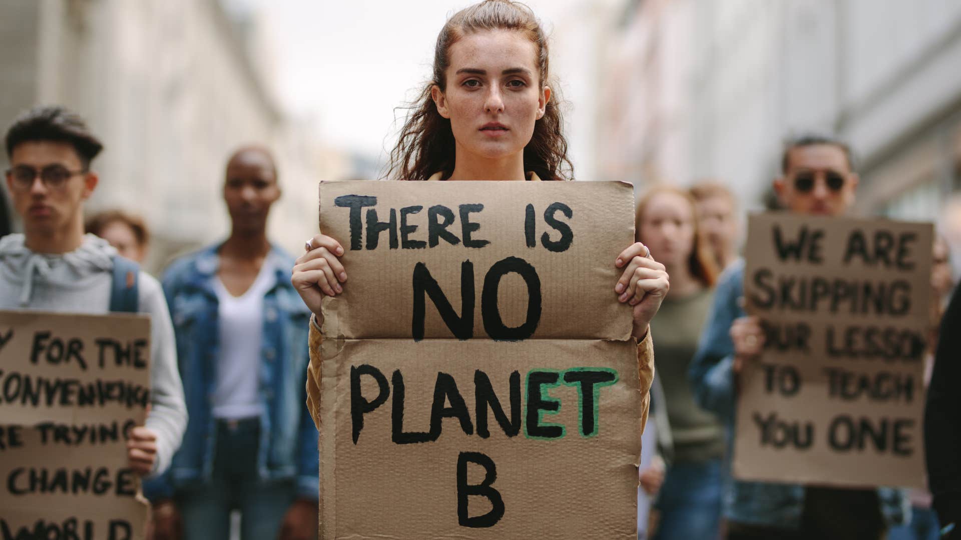 protestors holding posters about climate change