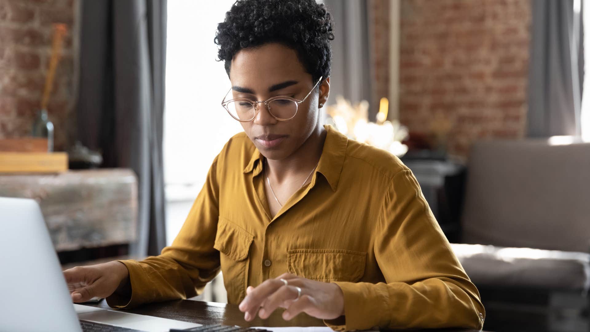 woman ignoring typical sacrifice financial mindset doing bills