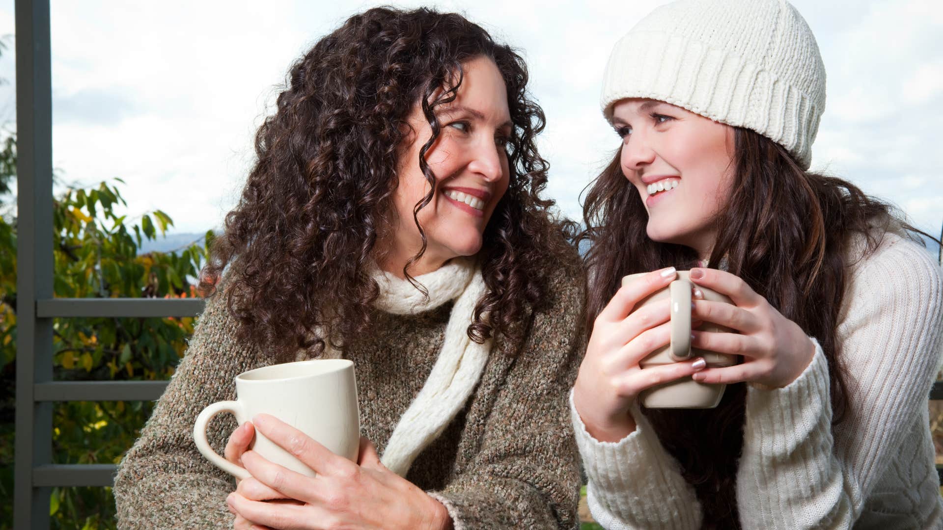 mom remembering the little things as mom and daughter are bundled up and enjoying a cup of coffee together