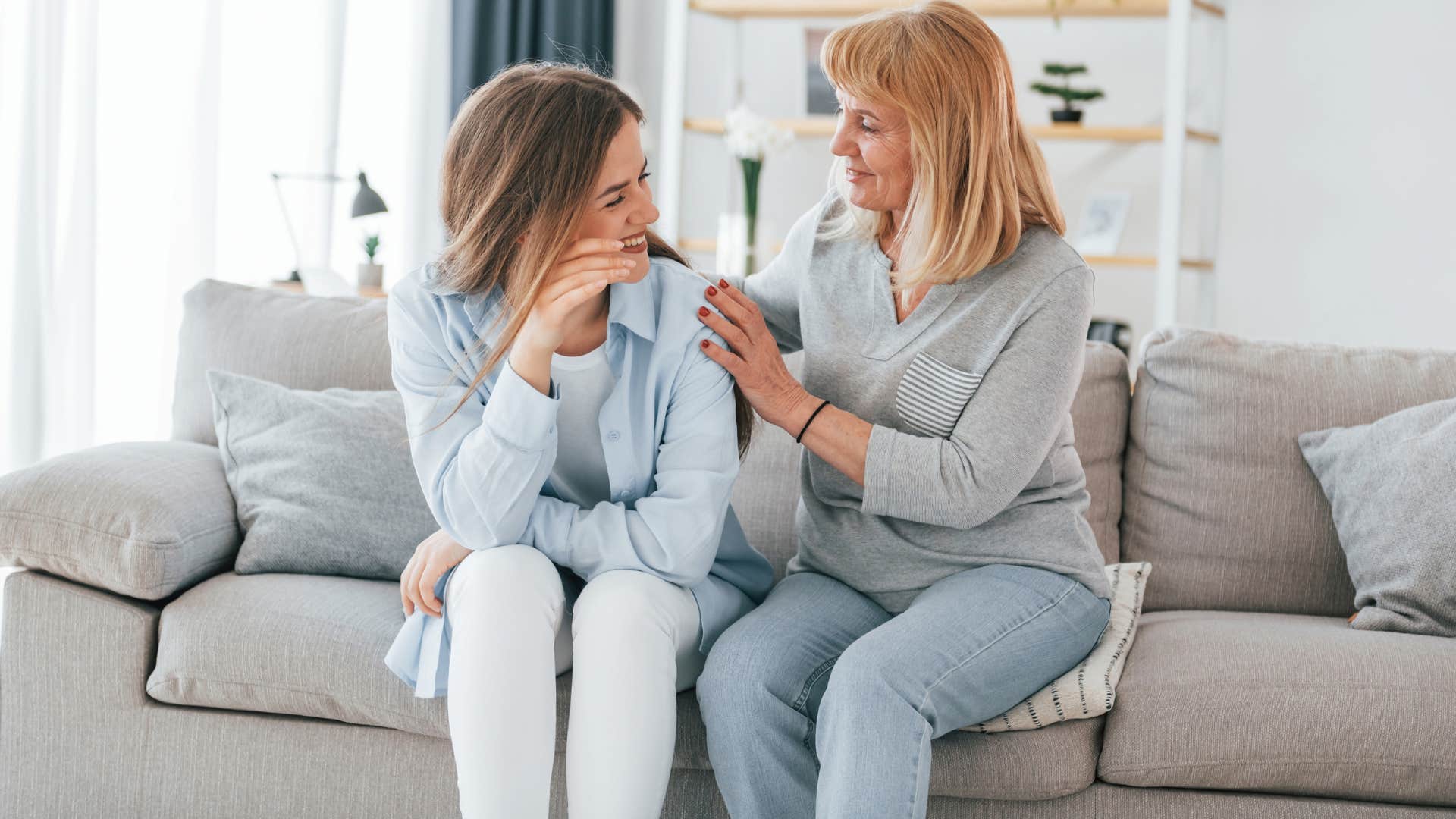 mom in gray shirt comforting daughter as she tries to be understanding 