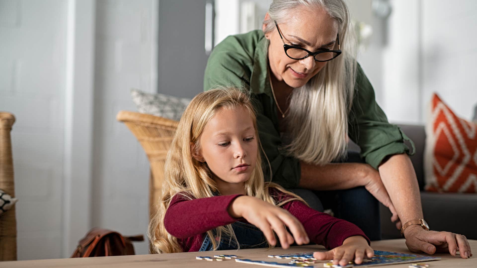 high iq woman and young girl doing puzzle together