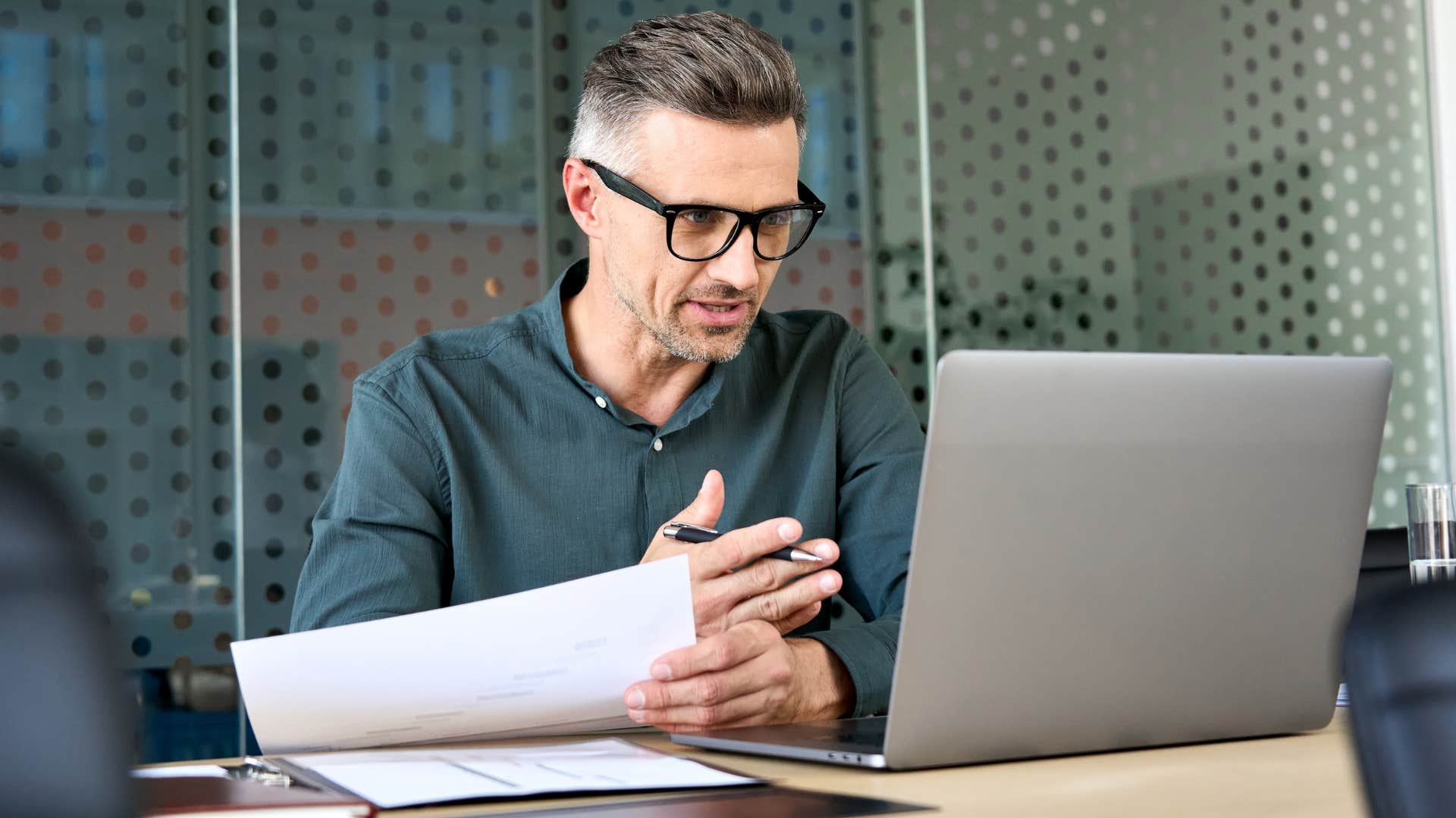 man pretending to enjoy a meeting that could have been an email