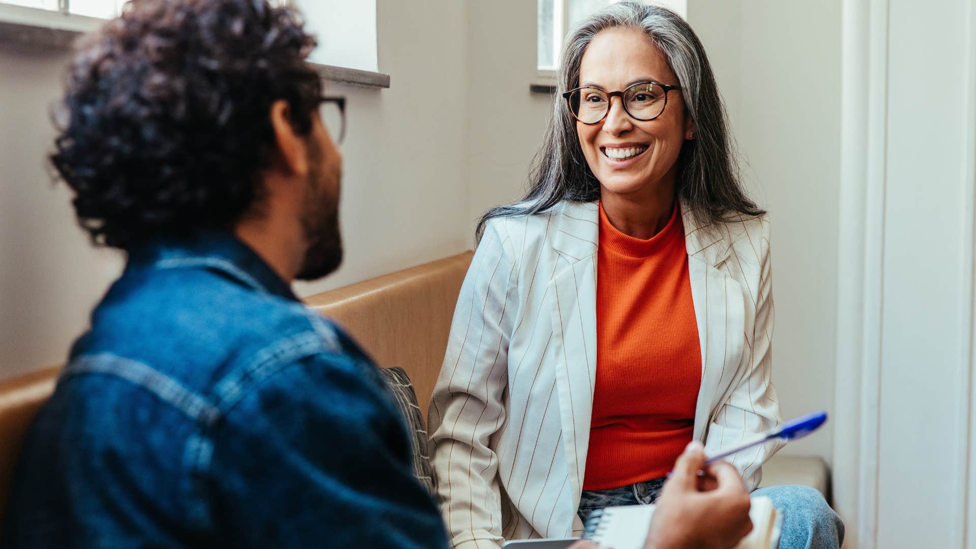woman following societal norms smiling at co-worker