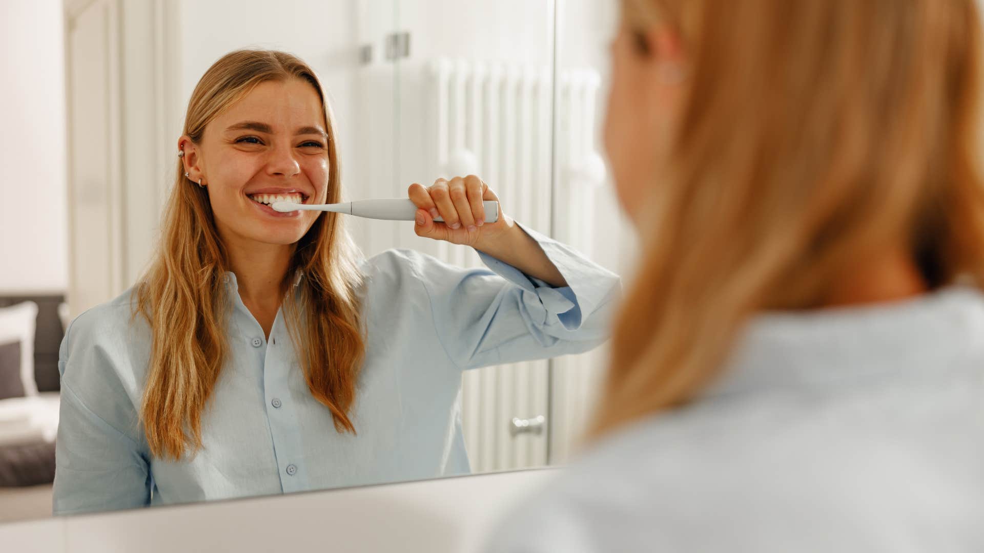 Woman uses old bathroom toothbrush 
