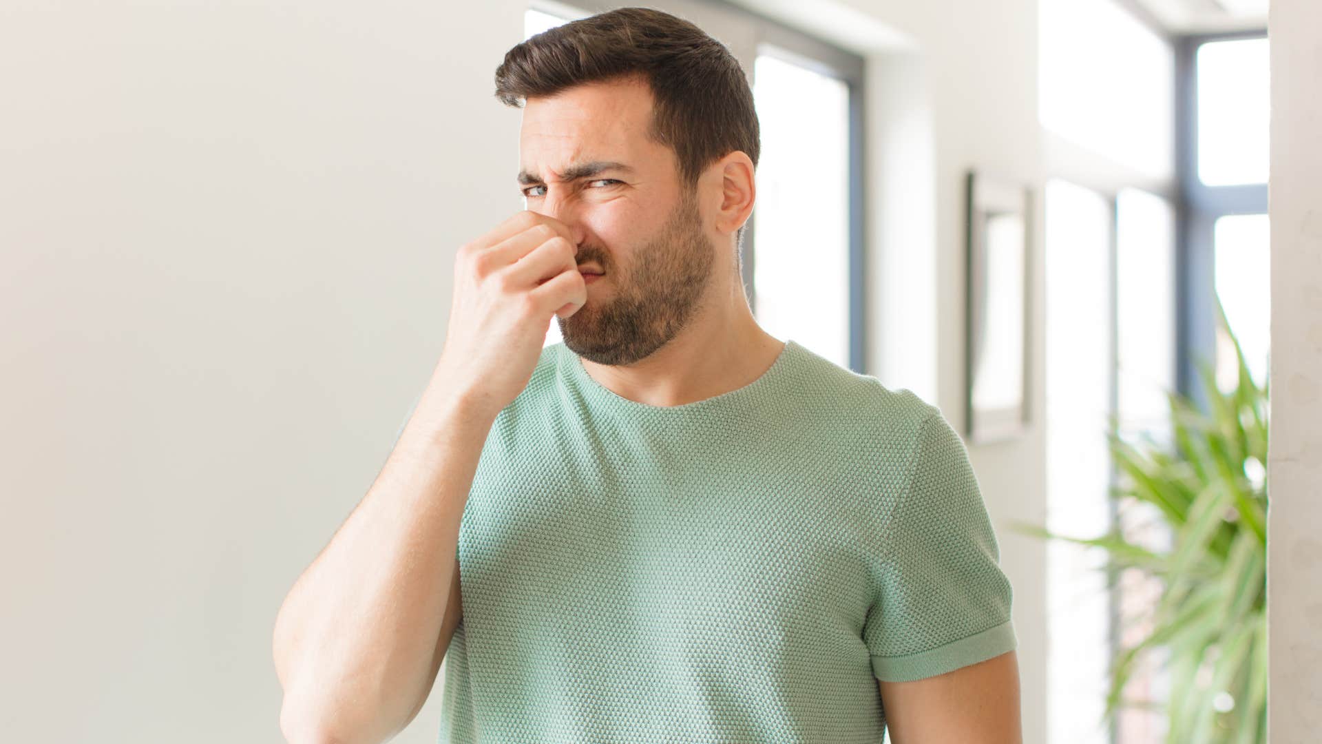 Man smells overwhelming bathroom scent