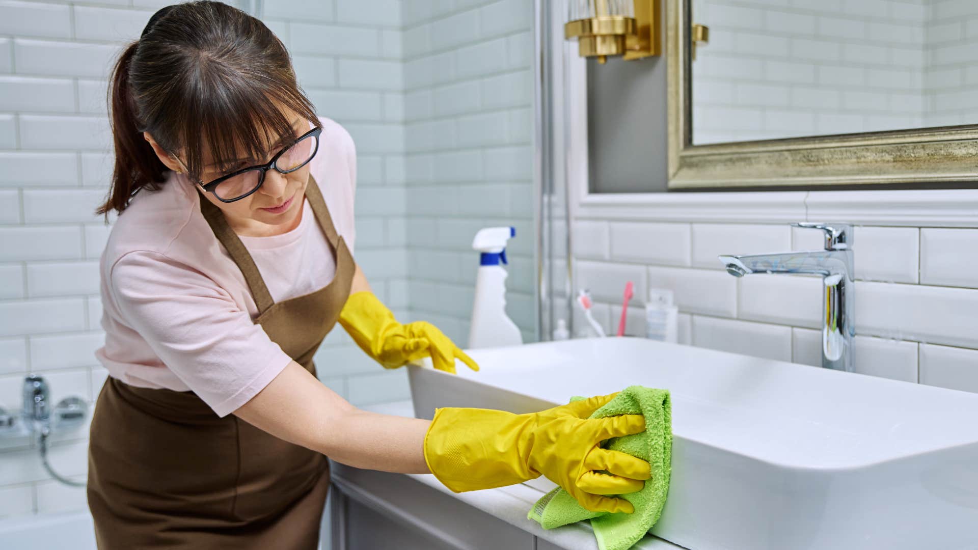 Woman cleans bathroom stains