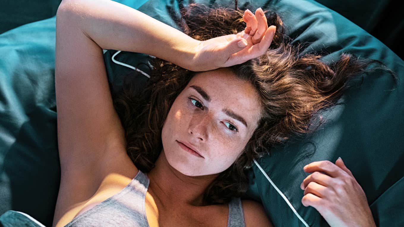 If These Things Keep Showing Up in Your Dreams, It Might Not Be Random Woman waking up from a dream.