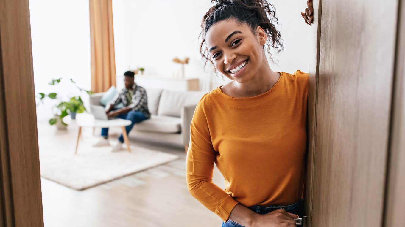 Things That Instantly Make People Feel Uncomfortable In Someone Else's Home woman welcoming guests into her home