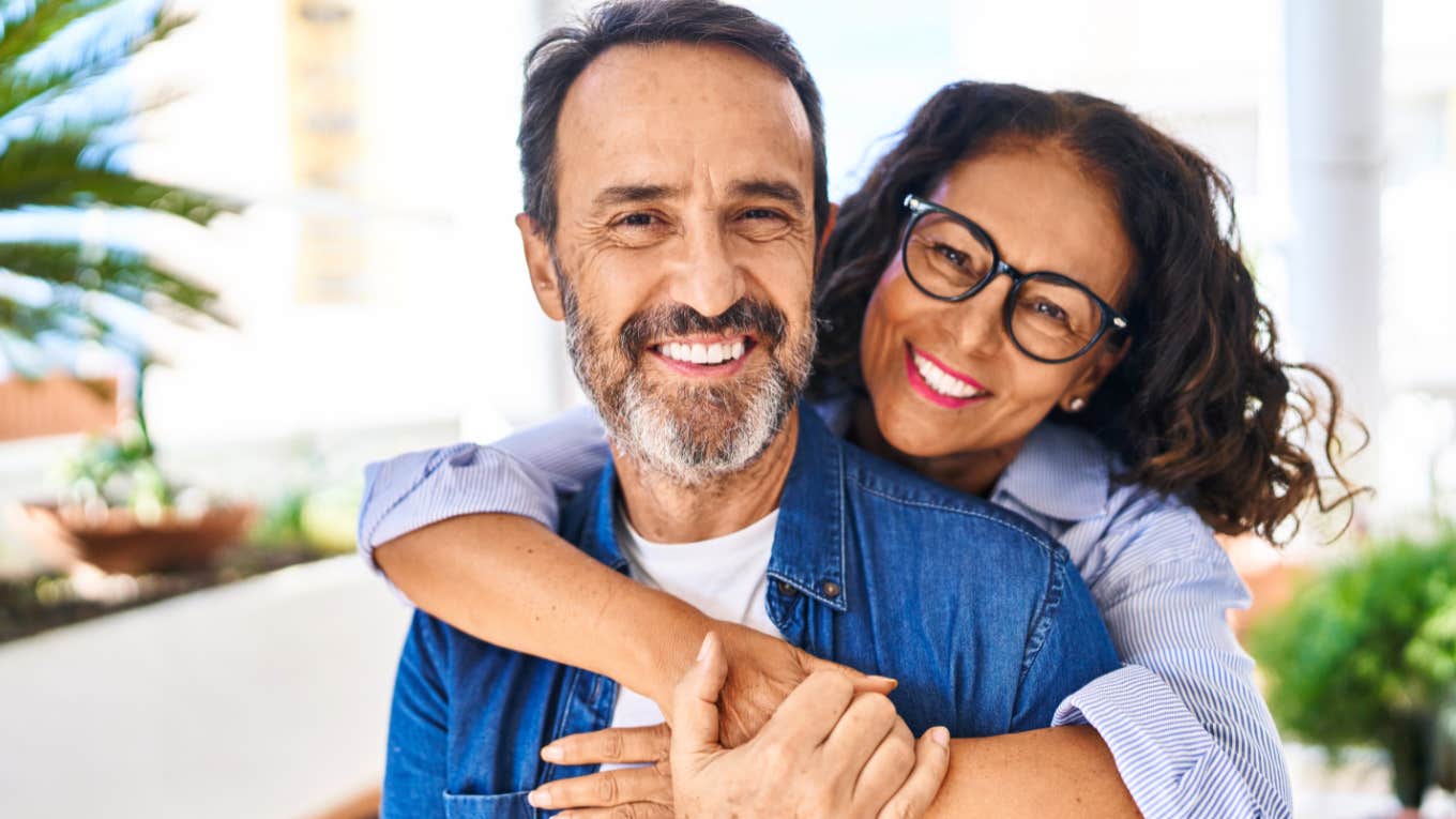 Things A Man Should Never Have To Ask For In A Relationship happy couple woman hugging man smiling