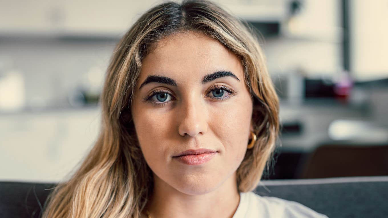 Things Millennials Secretly Blame Their Parents For, Even If They'd Never Say It Out Loud serious millennial woman thinking about how her parents raised her