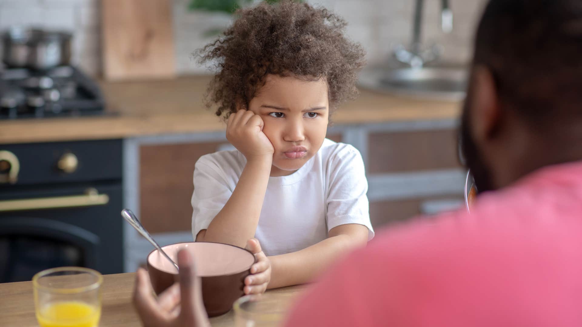 man instilling toxic relationship around food with young son