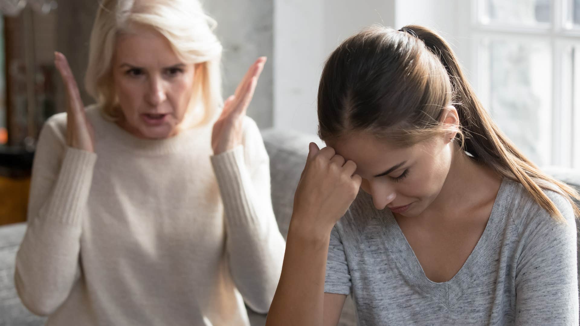 Woman denying climate change behind her upset daughter.