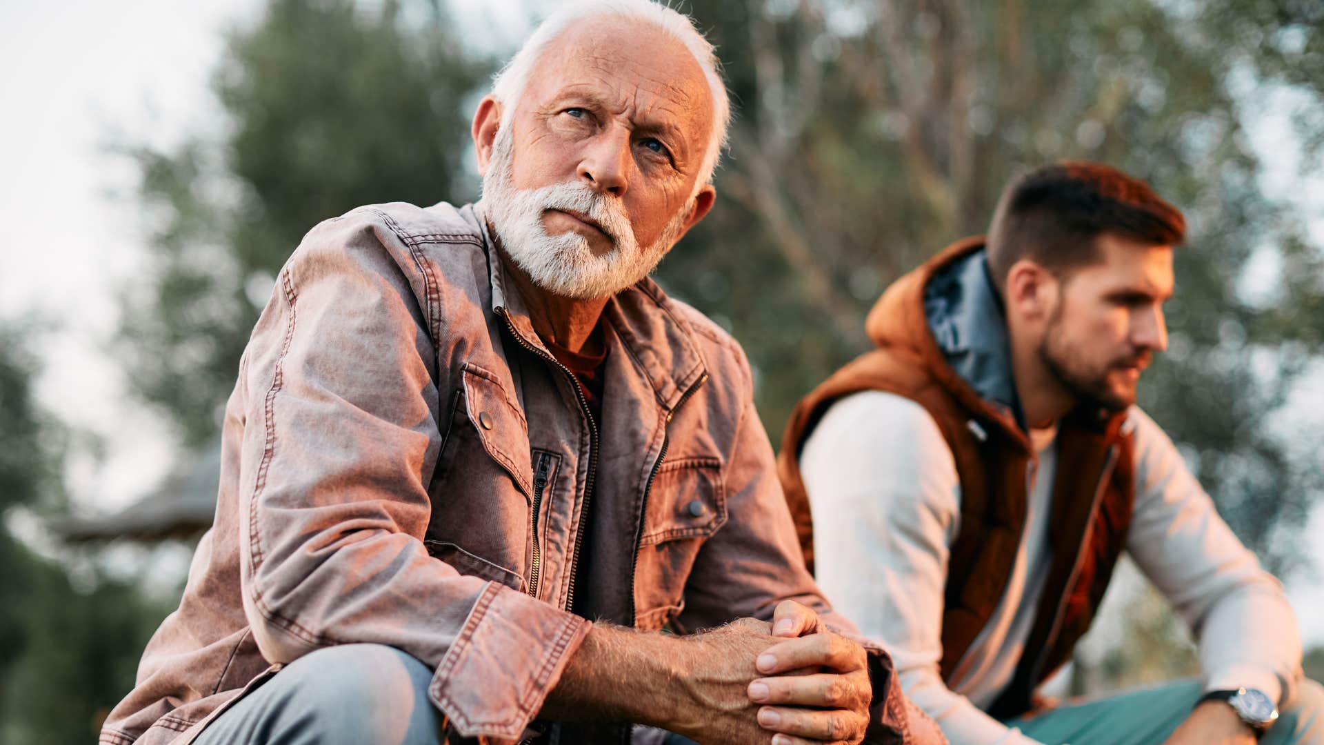 Man demonizing differing opinions next to his upset adult son.