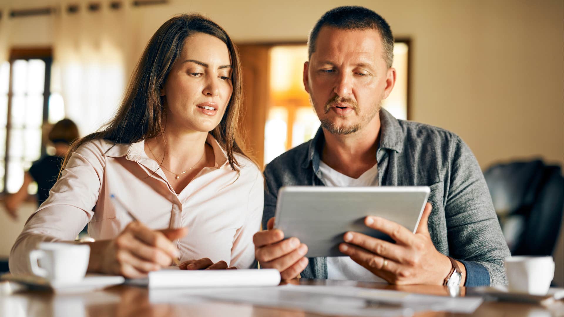Couple does paperwork before guests come over