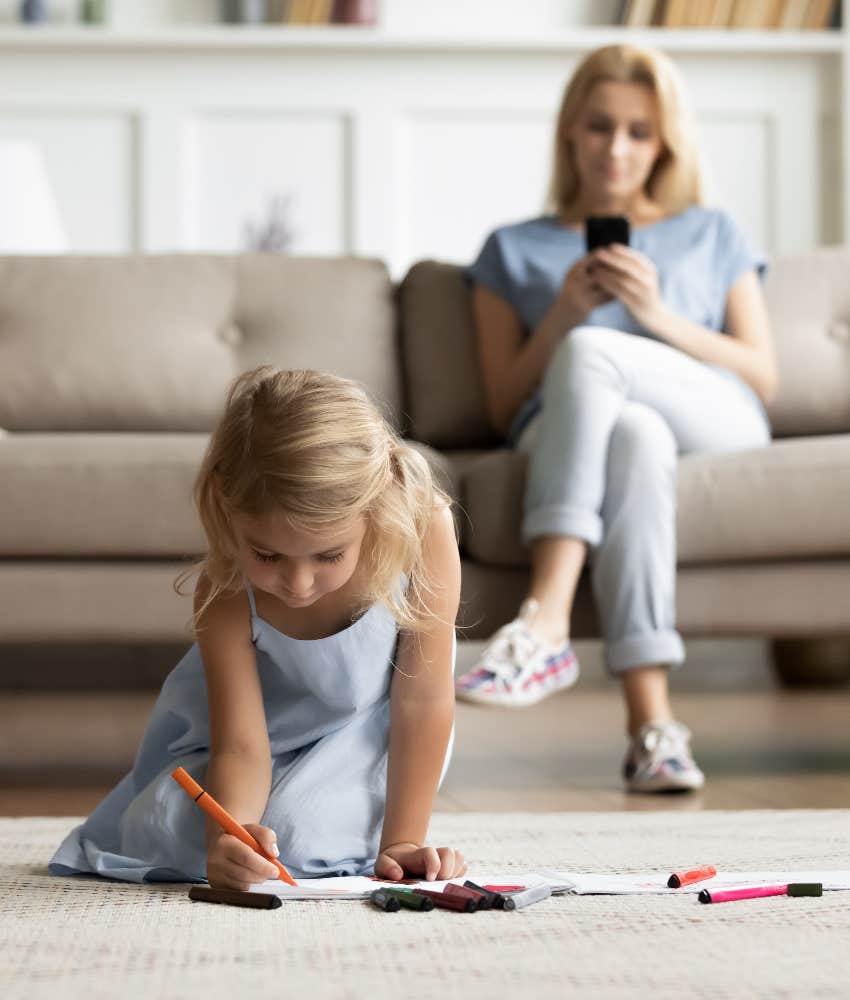 parent breaking her kids heart by looking at her phone during playtime