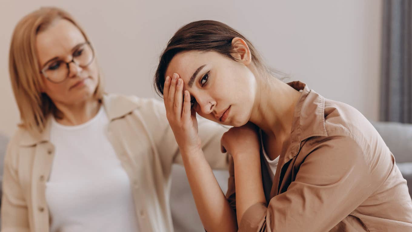 Things Parents Do Without Realizing To Make Their Adult Kids Feel Like They're Failing upset woman sitting next to mother who makes her feel like a failure