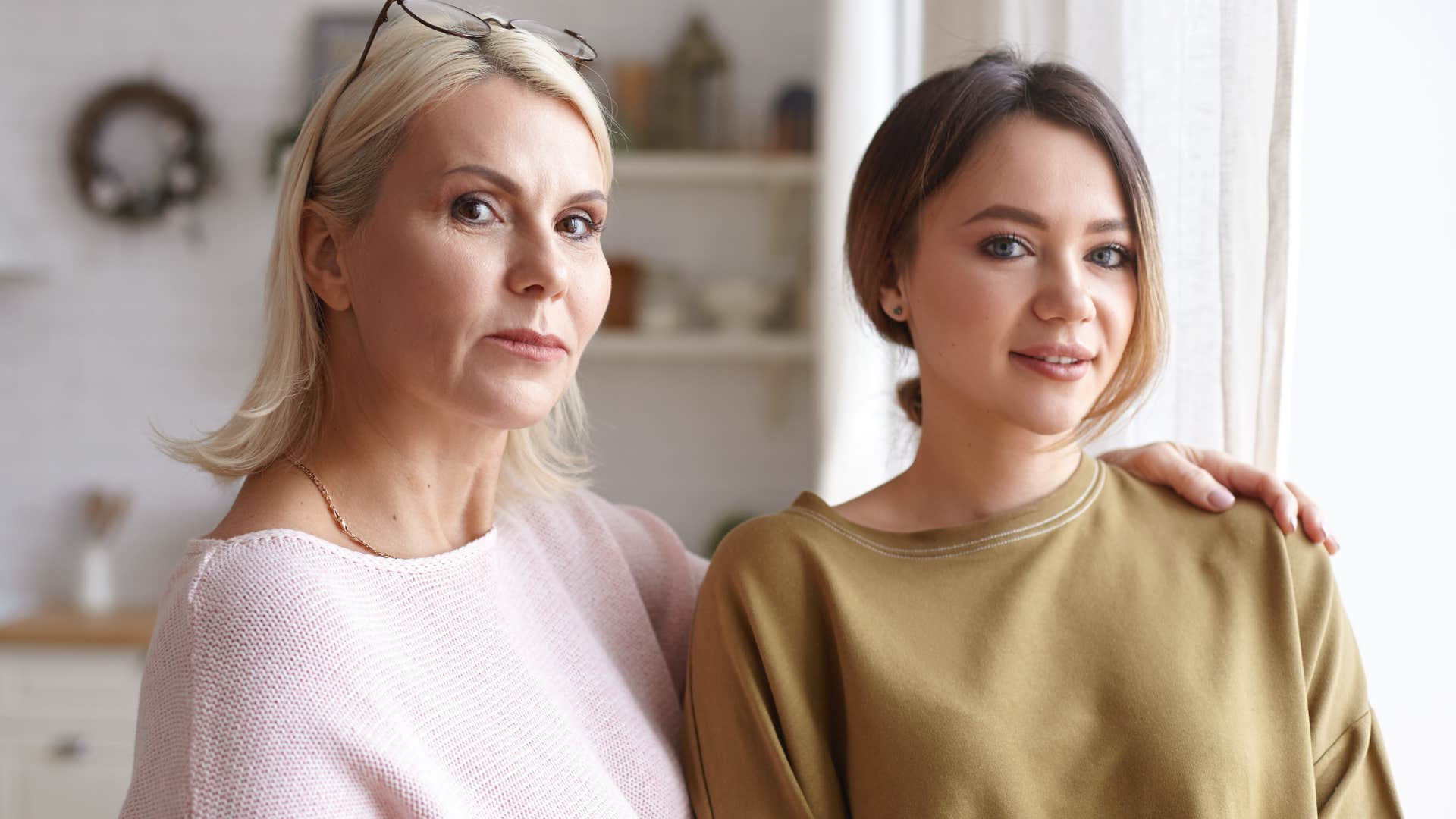 woman standing next to her adult daughter and comparing her