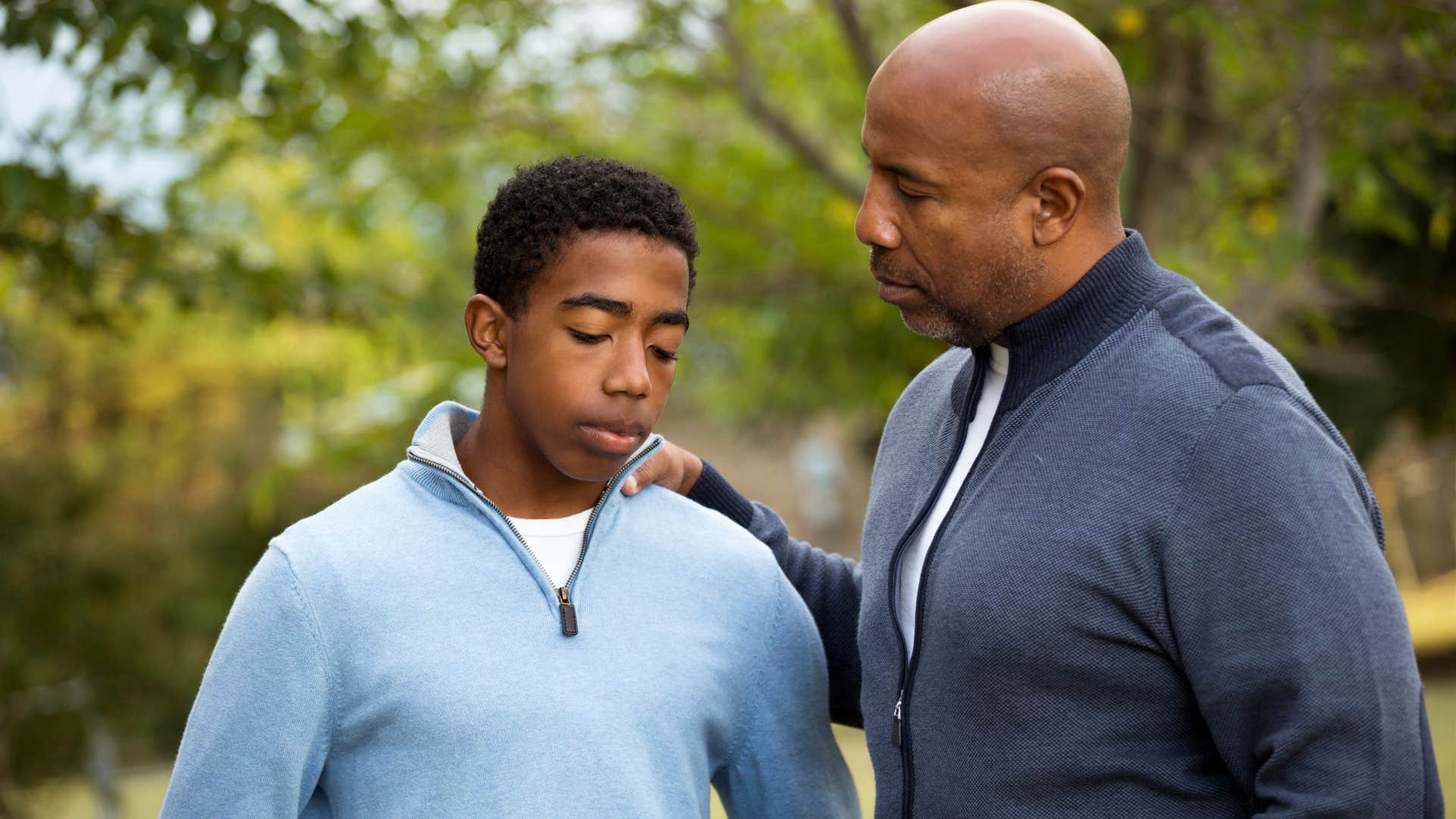 man comforting son trying to solve his problems