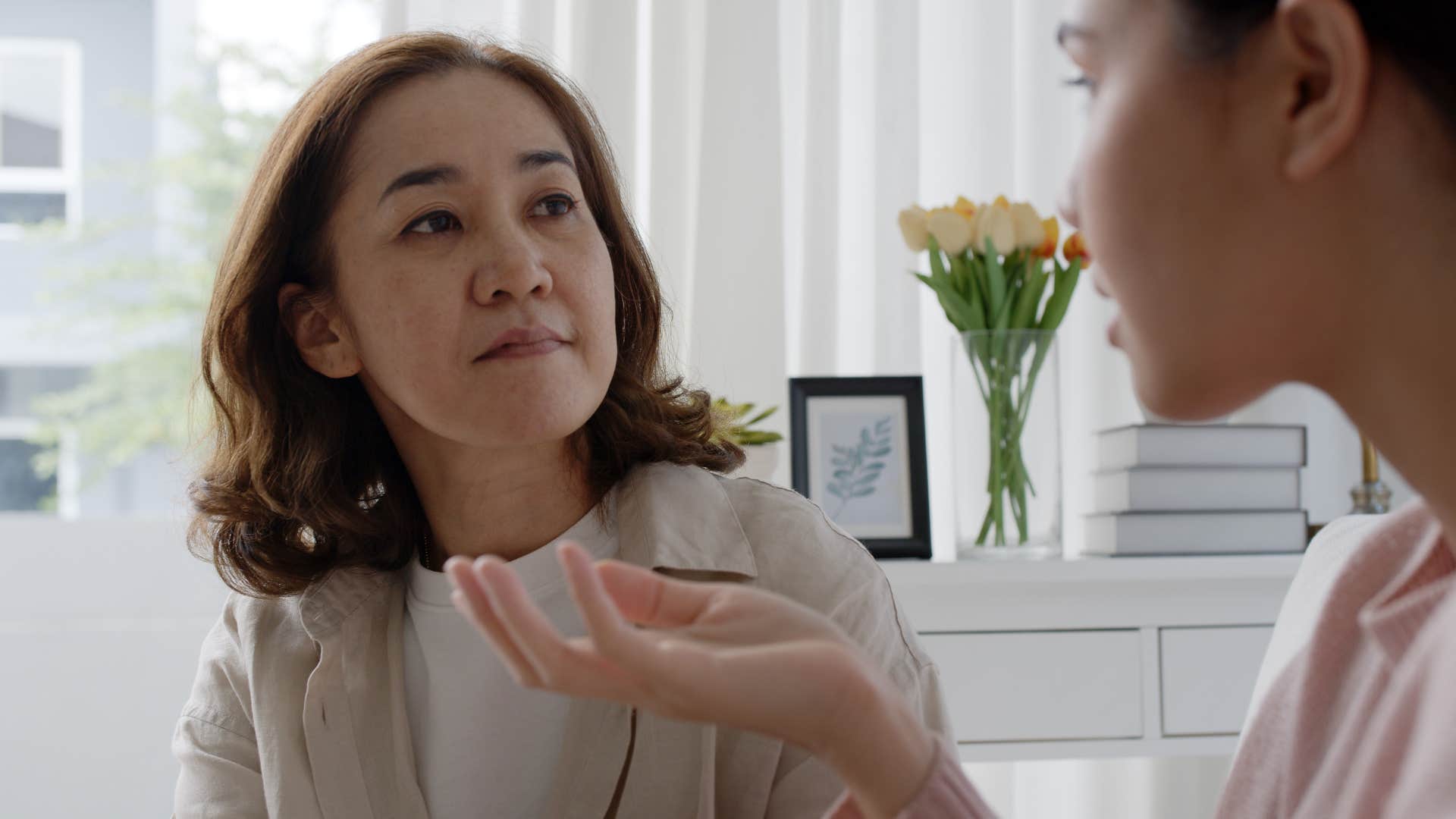 woman giving unsolicited advice to her adult daughter