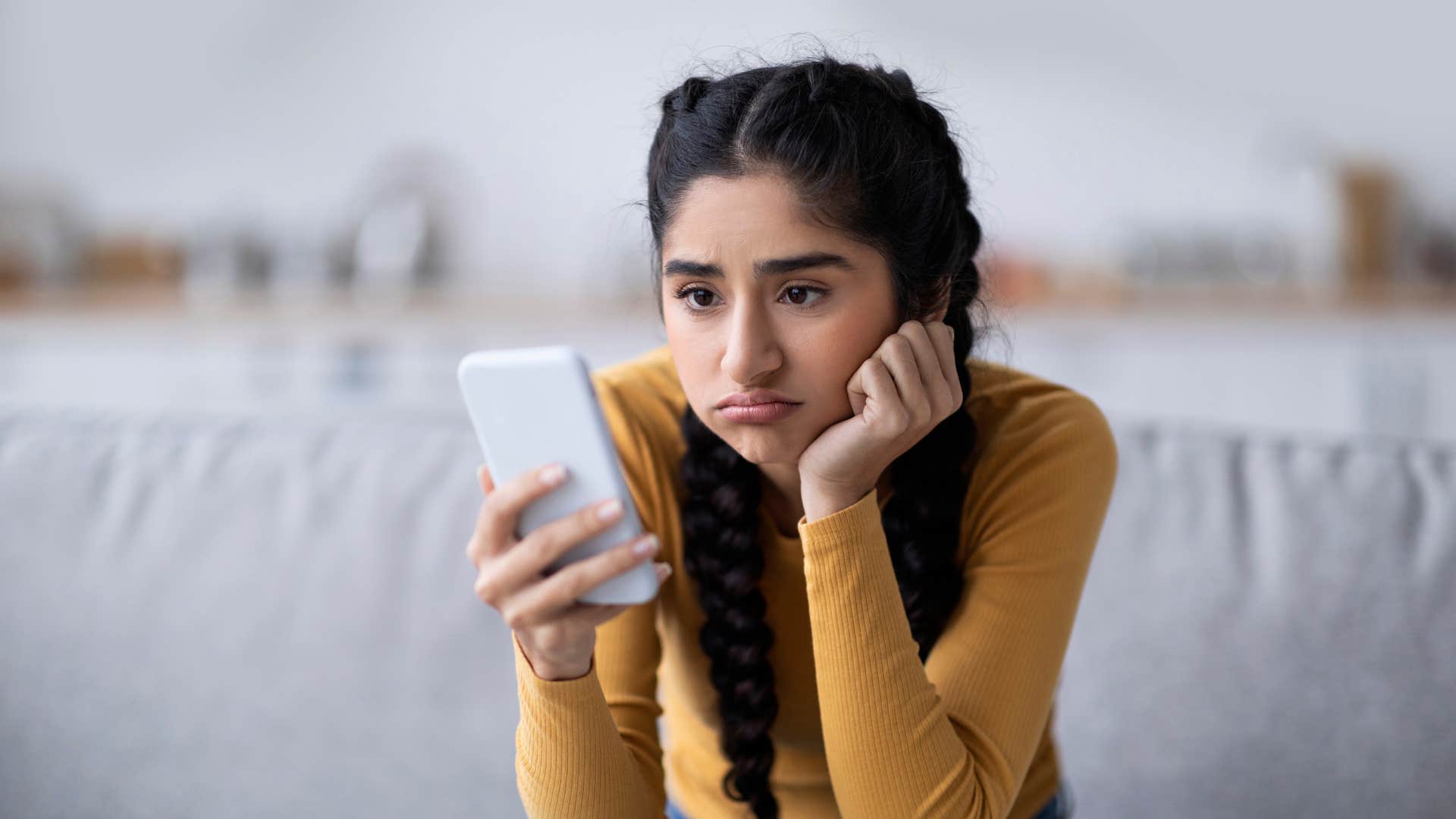 a young girl avoids deep conversations with her friends on her cell phone