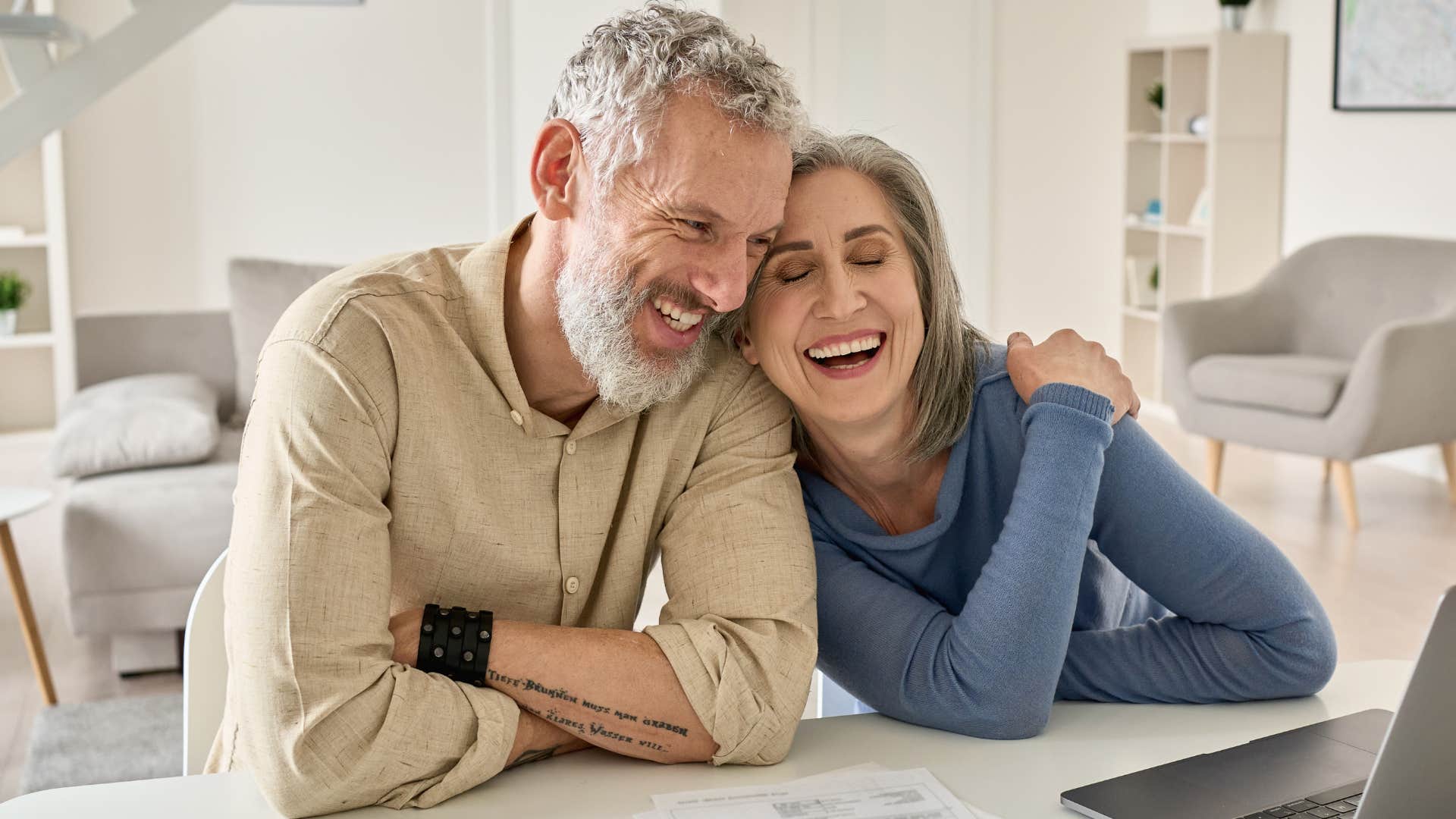 happy couple who isn't burdened by monthly bills