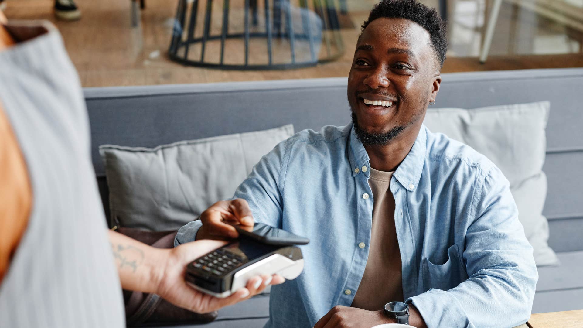 wealthy man who can afford upcharges paying at a restaurant