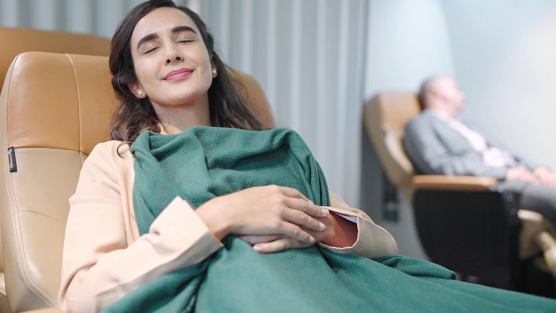 woman after getting a luxury travel upgrade on a flight