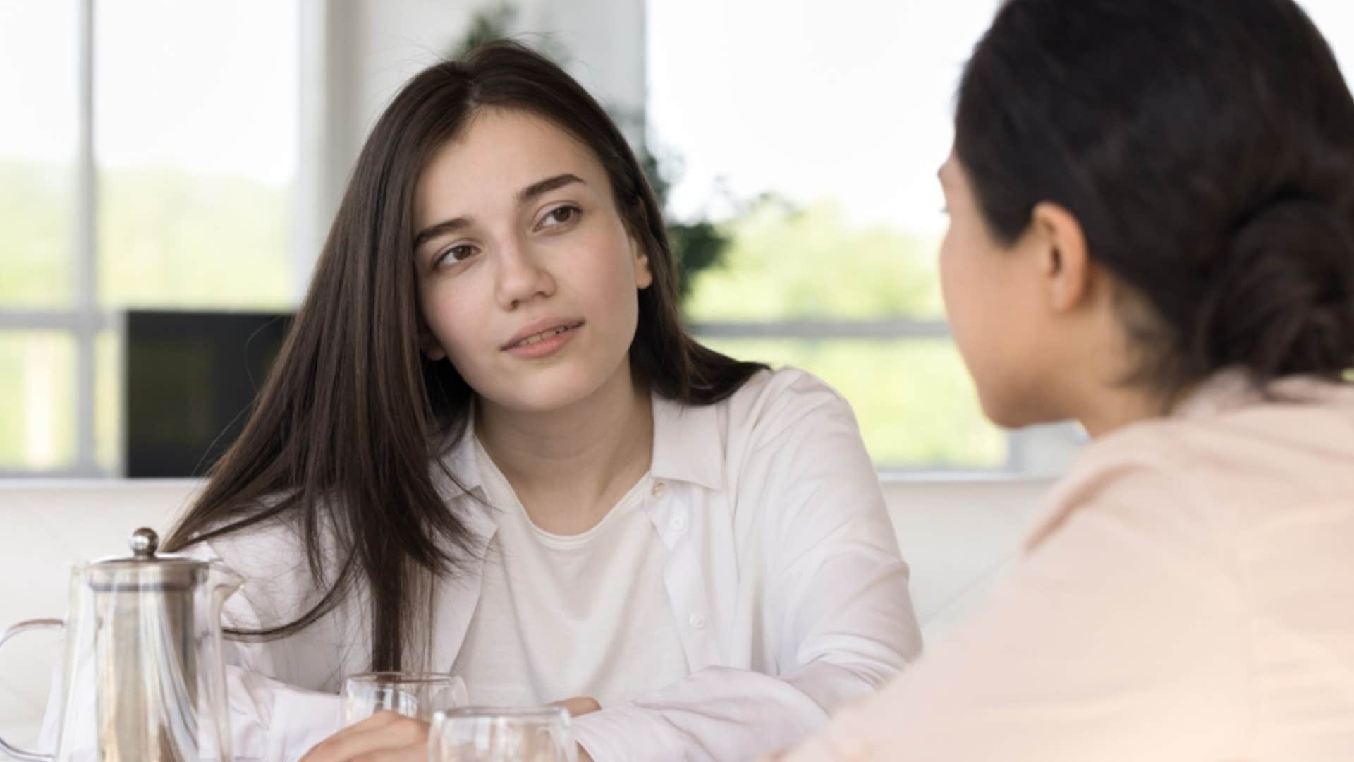 people pleasing woman agreeing with colleague who has different beliefs 