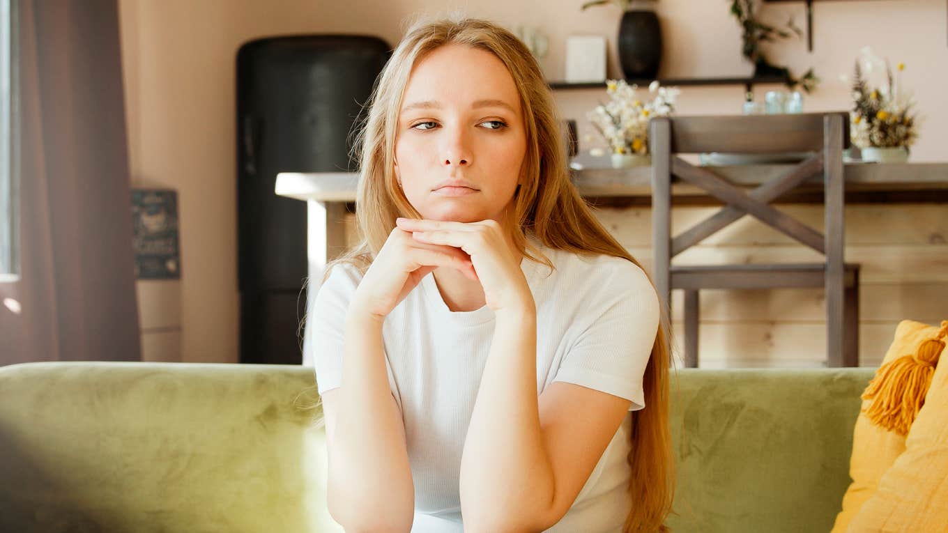 Things People-Pleasers Secretly Resent But Still Keep Doing Out Of Guilt resentful woman thinking on couch