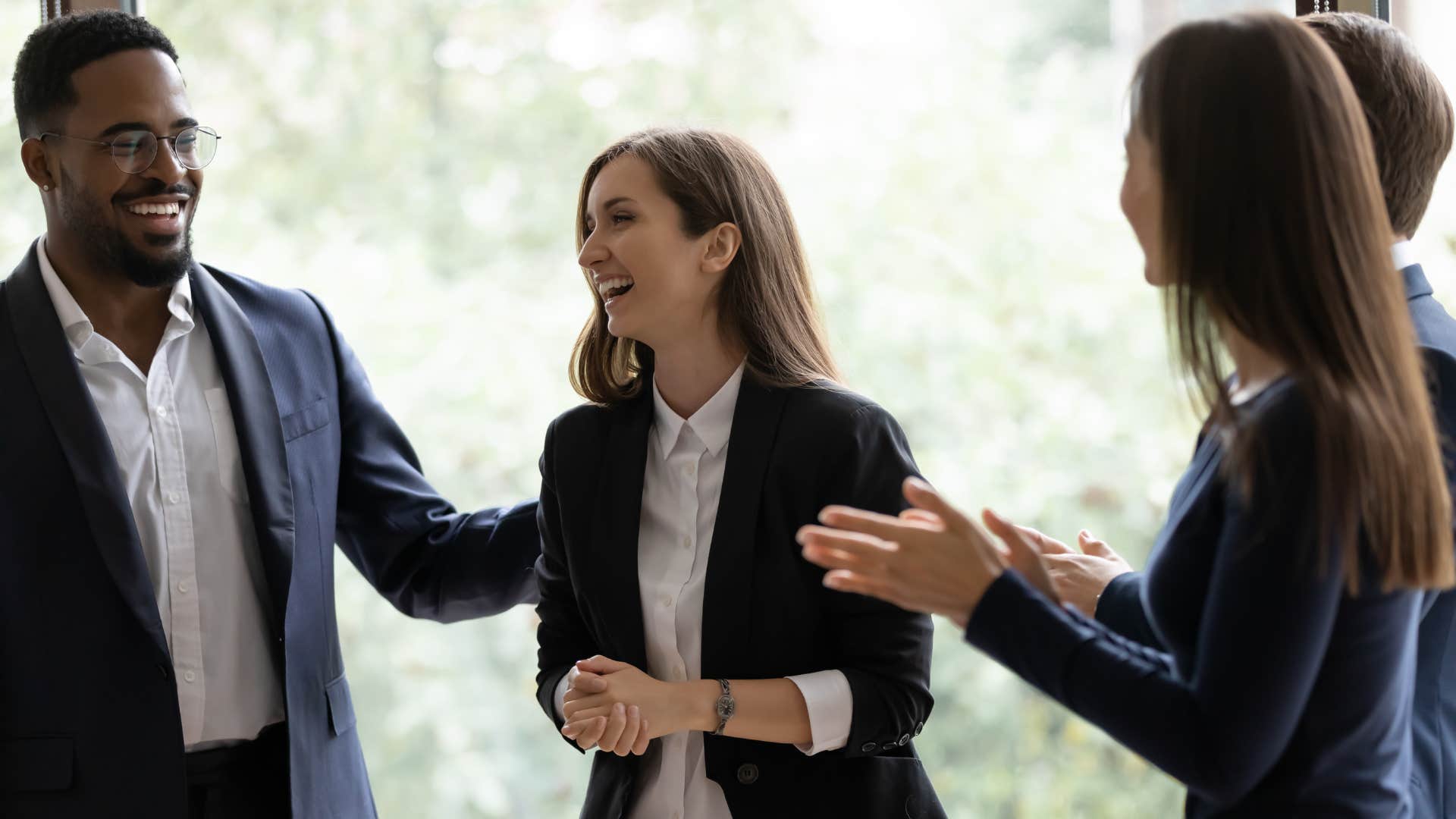 woman smiling and proud of herself as she celebrates her accomplishments in life with coworkers