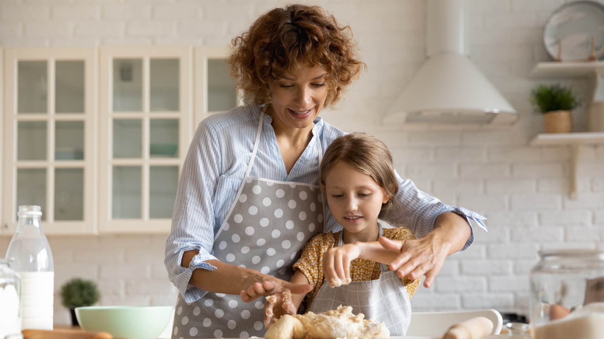 a woman and her young daughter bake pastries for her friends birthday party