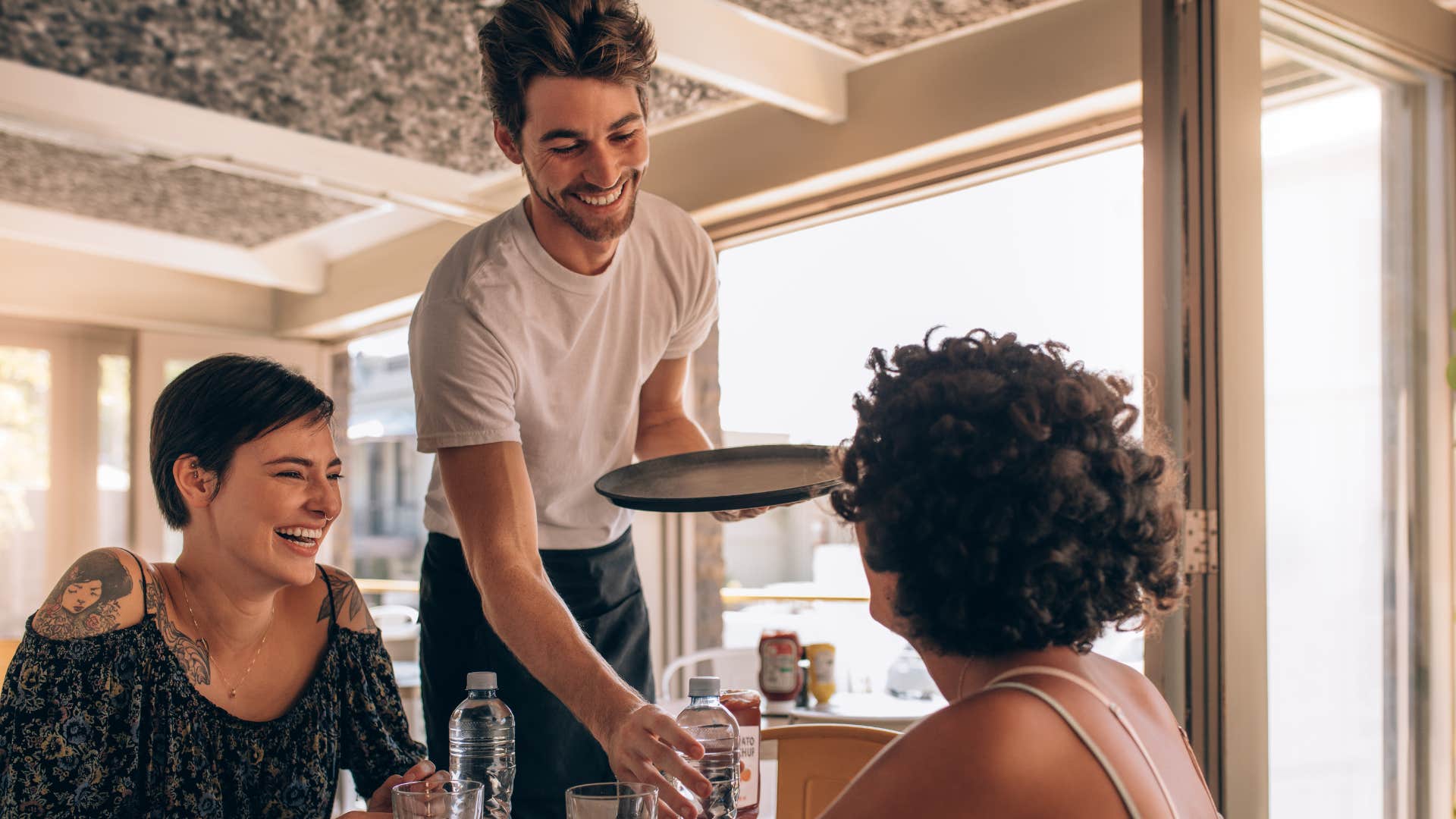 Two women order water at a restaurant