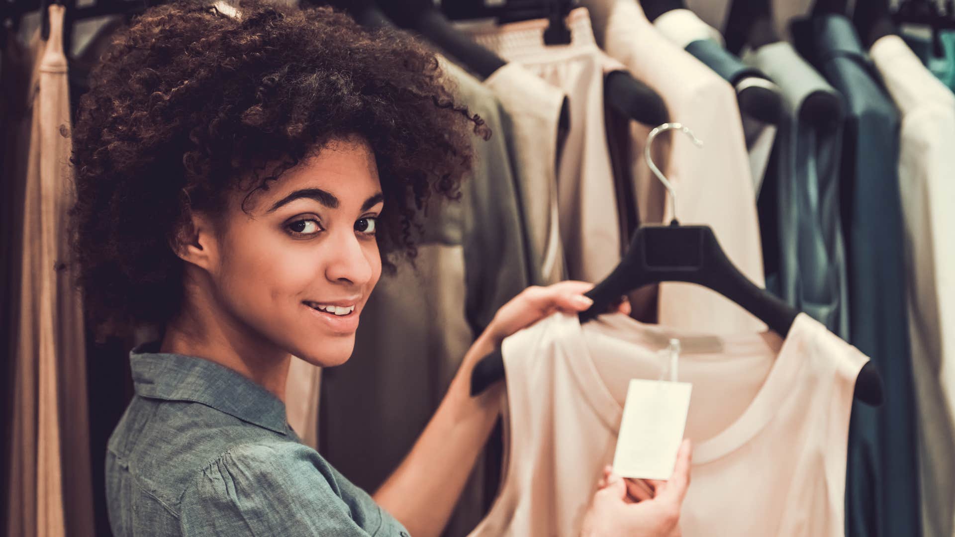 a woman checks out the prices in the clearance section