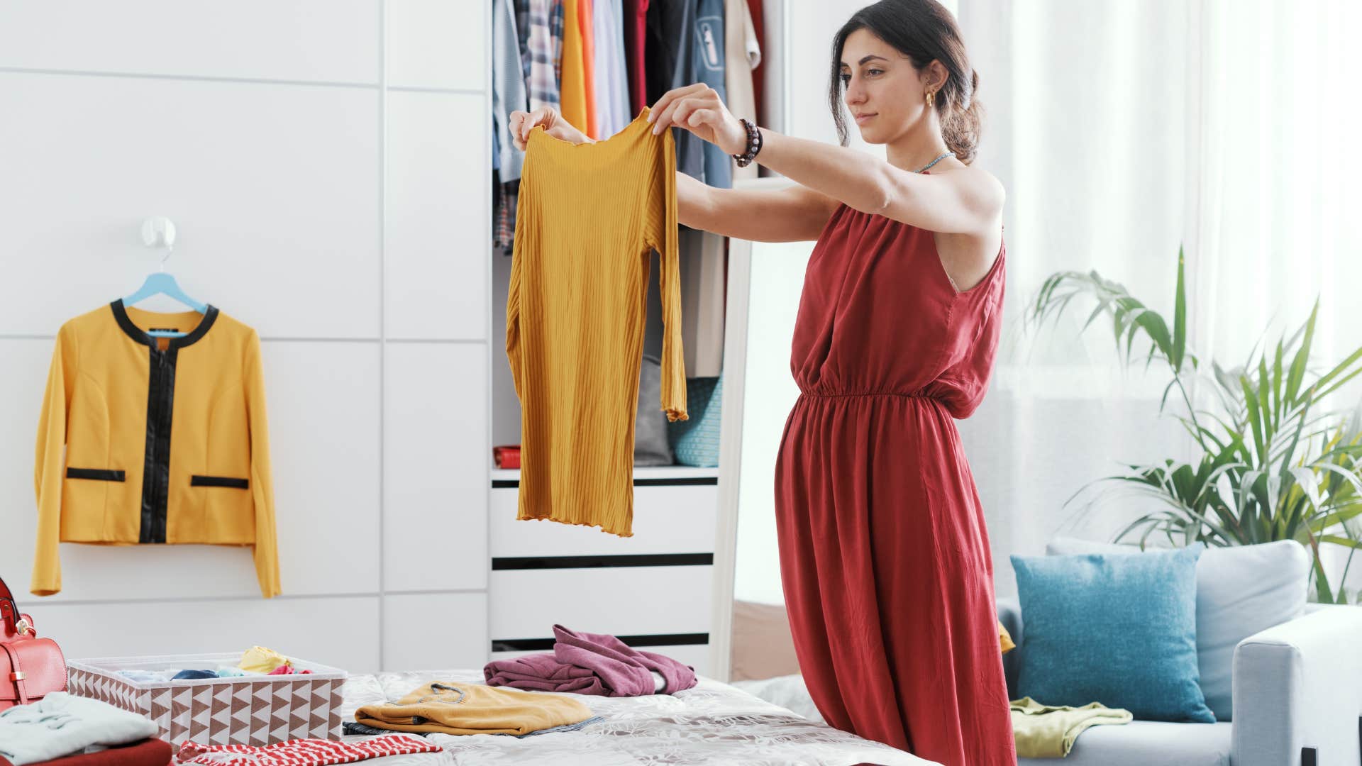 woman trying to declutter closet
