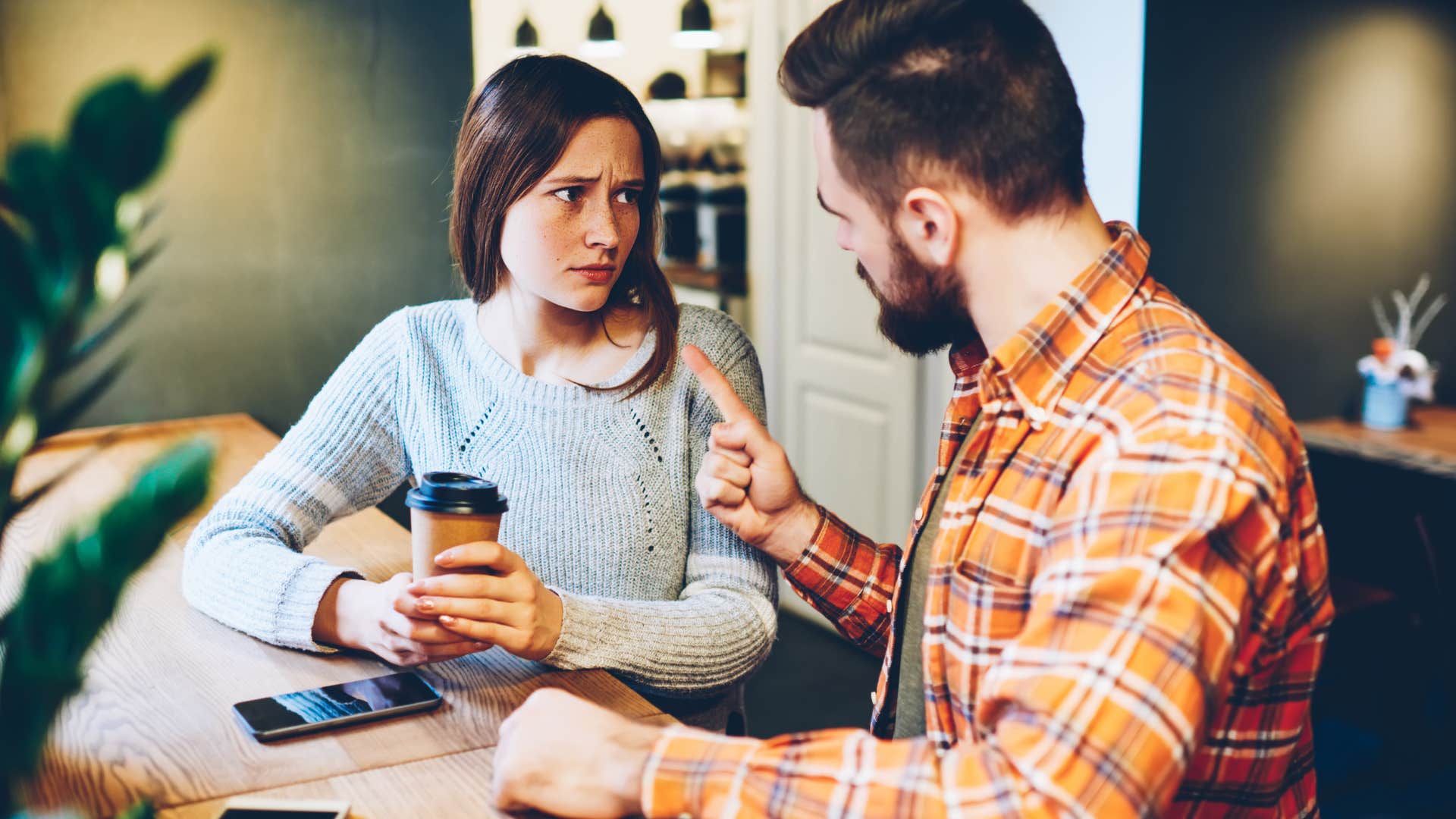couple talking woman asking if partner is mad at her