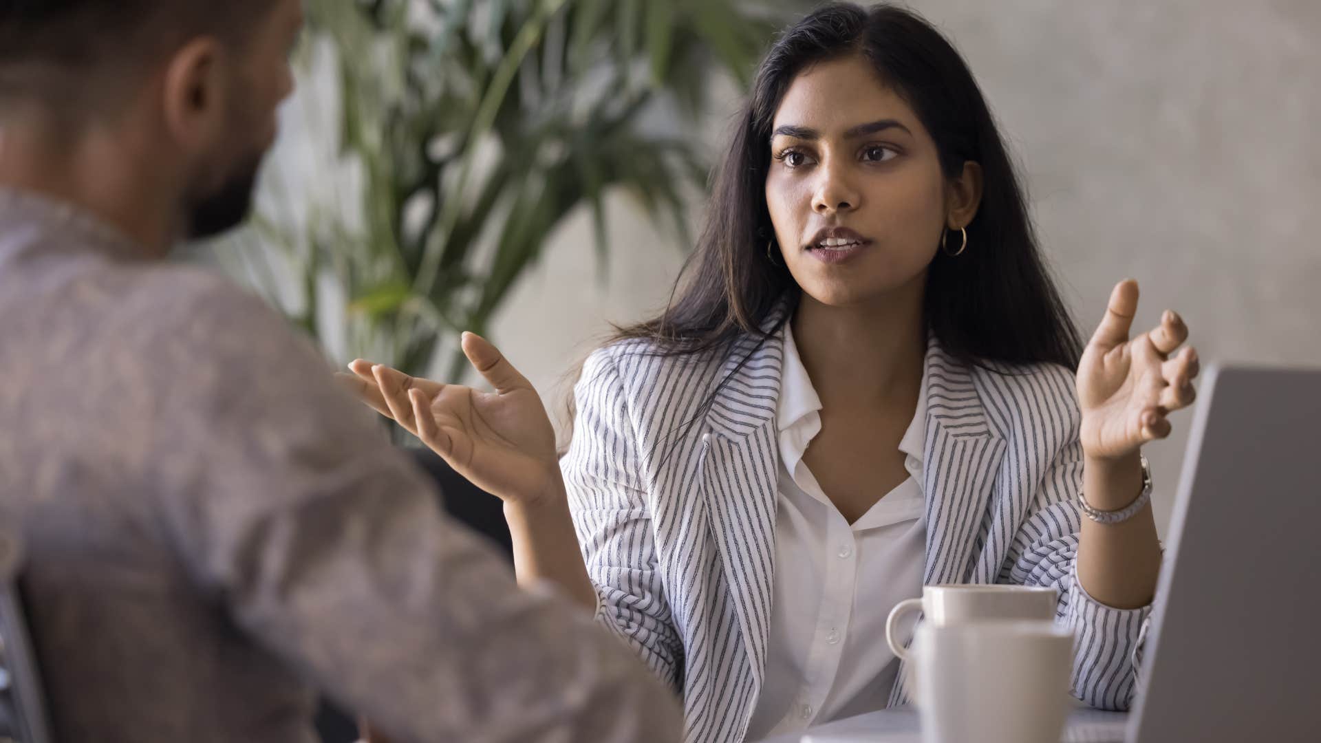 high iq woman pretending to enjoy talking to pretentious co-worker